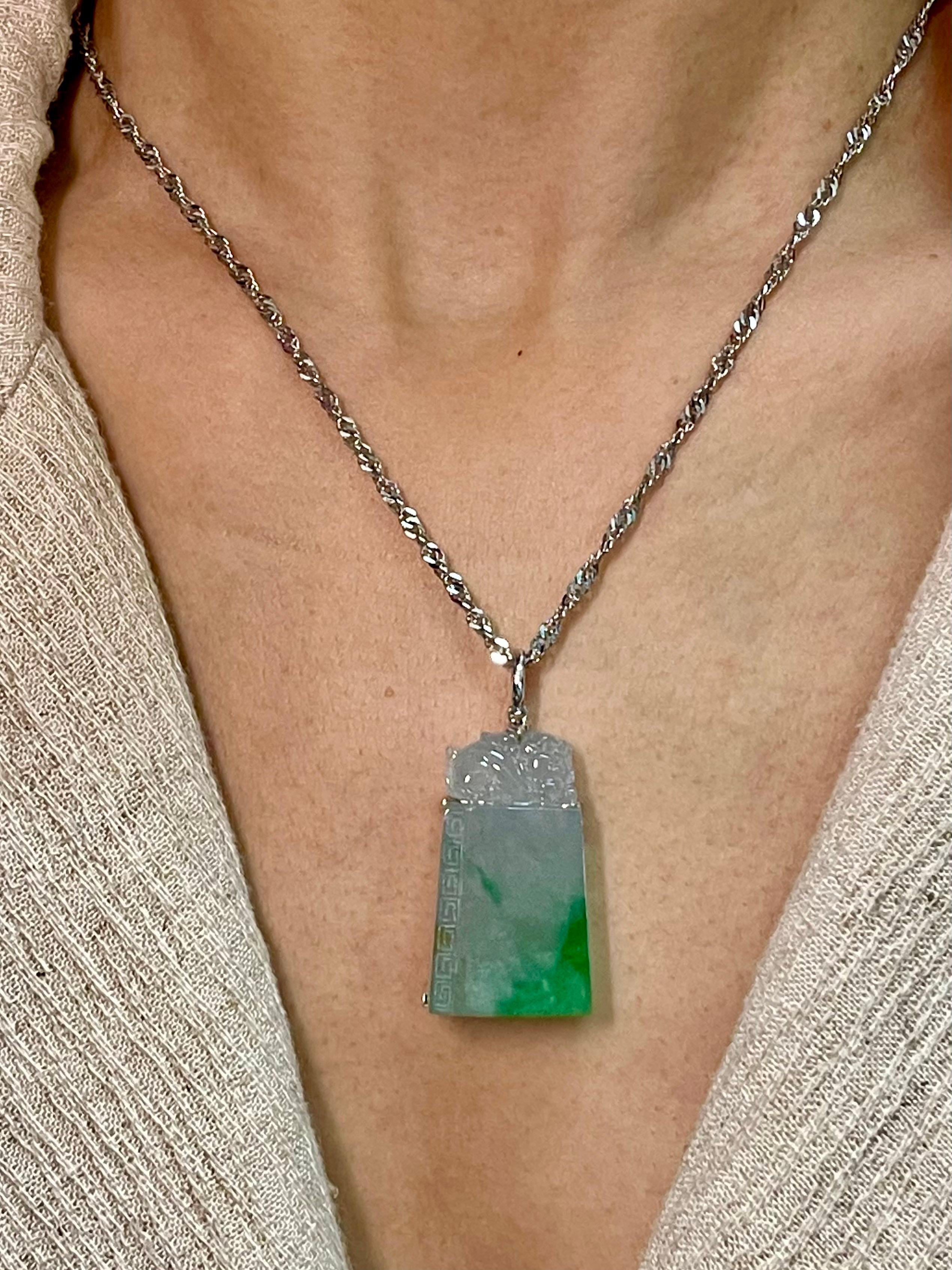 Please check out the HD video. This is certified natural jadeite jade by two labs. The carving on top is a Jade beast. Known for warding off evil. It is well carved. This jade pendant is almost 57cts not including the 18k white gold hand-made