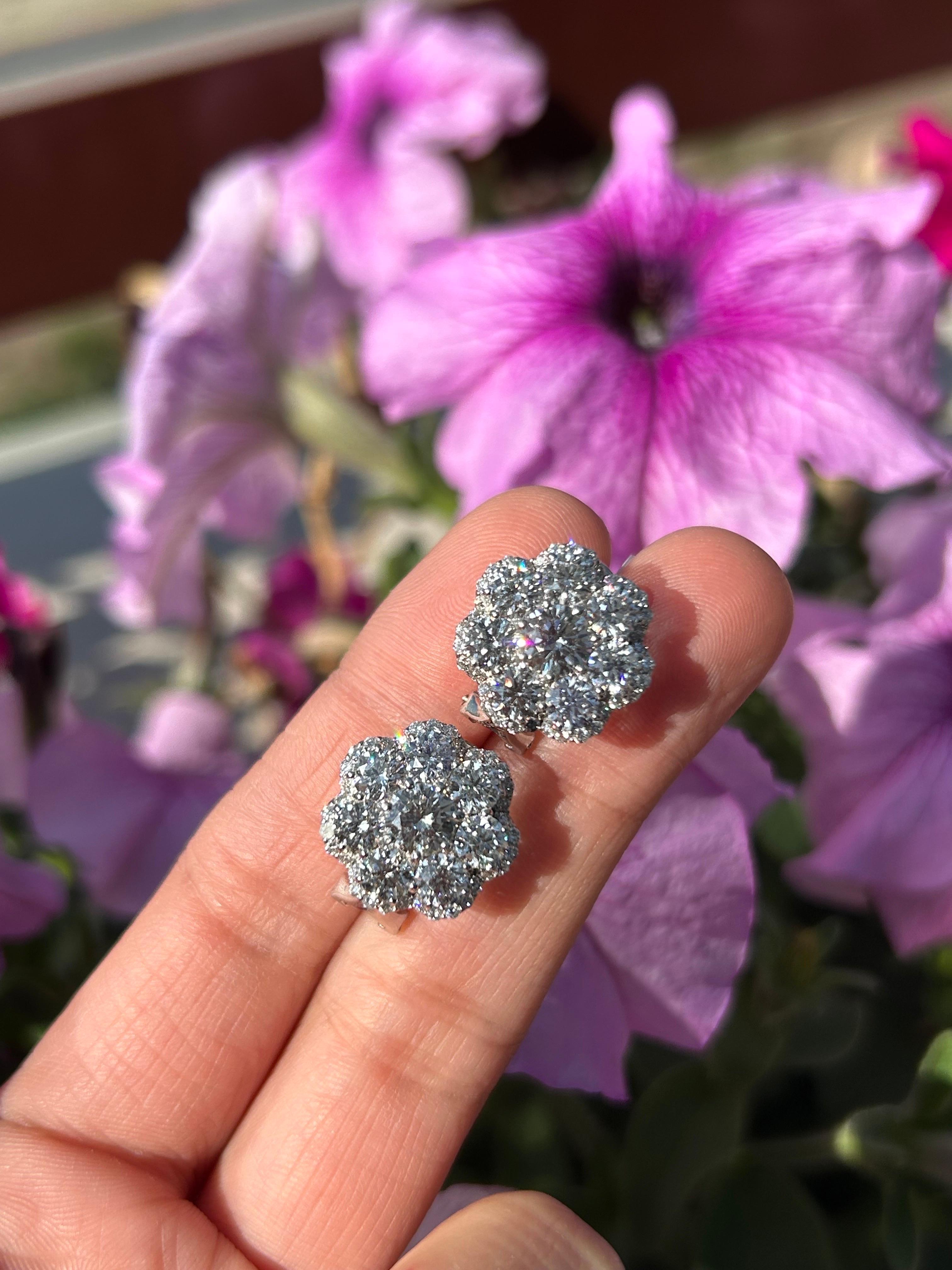A classic pair of beautifully handcrafted 5.71 carat Diamond studs, with center 50pointer diamonds and 30pointer diamonds surrounding it. The 5.15 carat larger diamonds are VVS quality, G/H color, and the smaller 0.56 carat diamonds are F/G color,