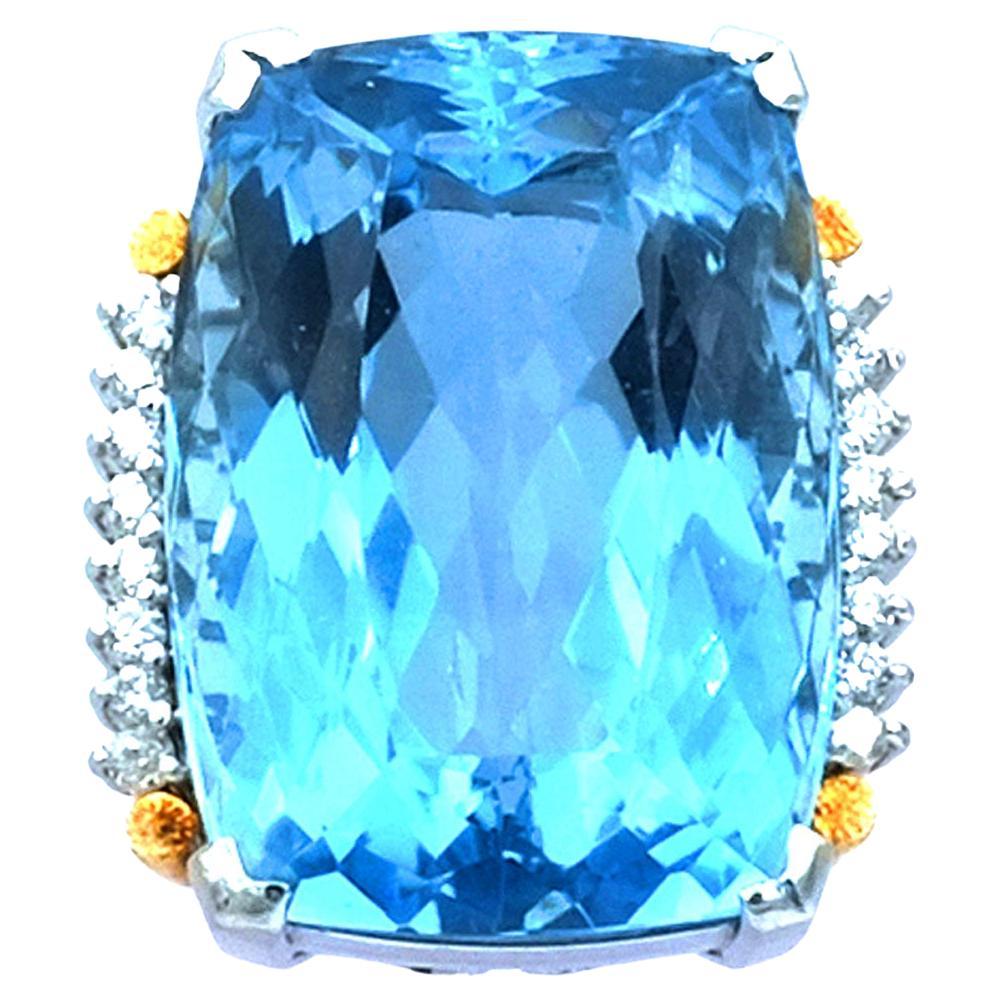 Certified 58 ct Blue Topaz Diamond Platinum and Gold Cocktail Ring circa 1940

Magnificent blue topaz diamond ring made of platinum and gold, the rectangular ring head set with a blue topaz weighing approx. 58 ct of a clear sky blue color and with