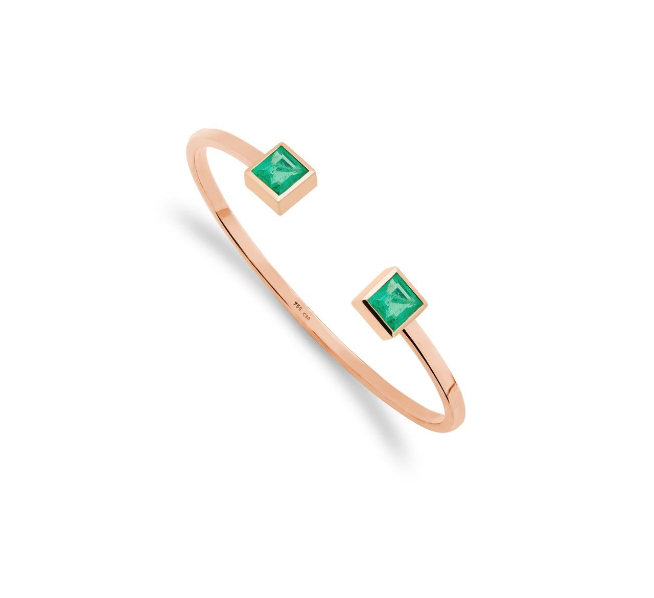 This beautiful purist rose 18K gold bangle with two wonderful 6.1 carat emeralds is exquisitely handmade by 
Colleen B. Rosenblat.