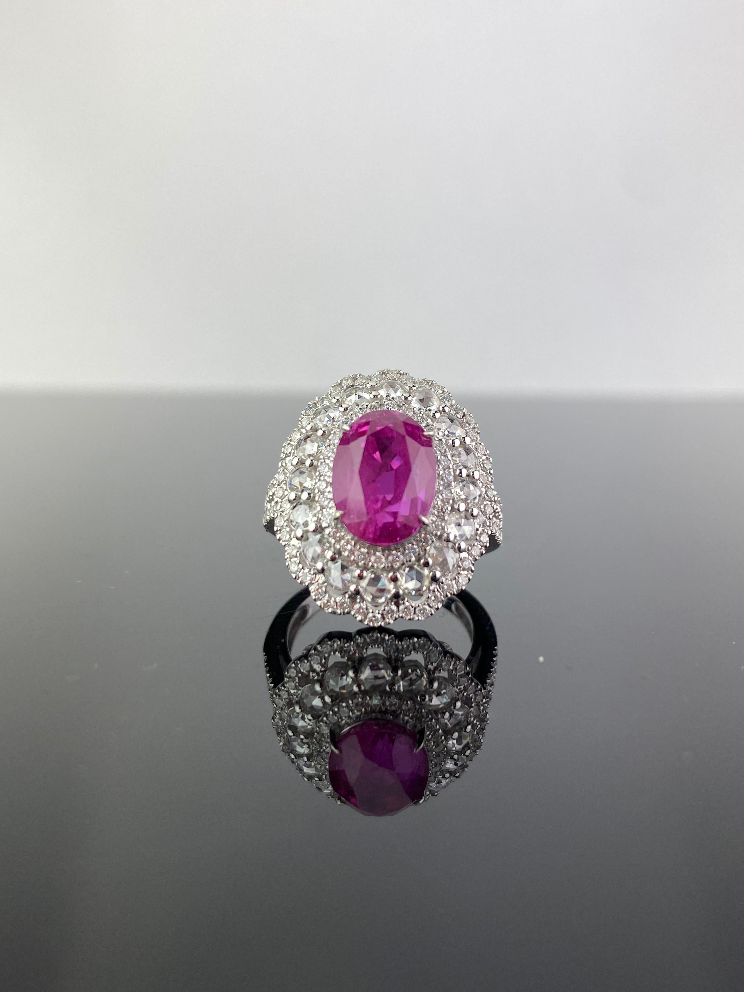 A beautiful 6.24 carat oval shaped natural Ruby and 1.39 carat rose cut and brilliant cut VS quality White Diamond cocktail ring. The gemstones are set in solid 18K White Gold, and is currently sized at US 7. 
The ring can be resized without