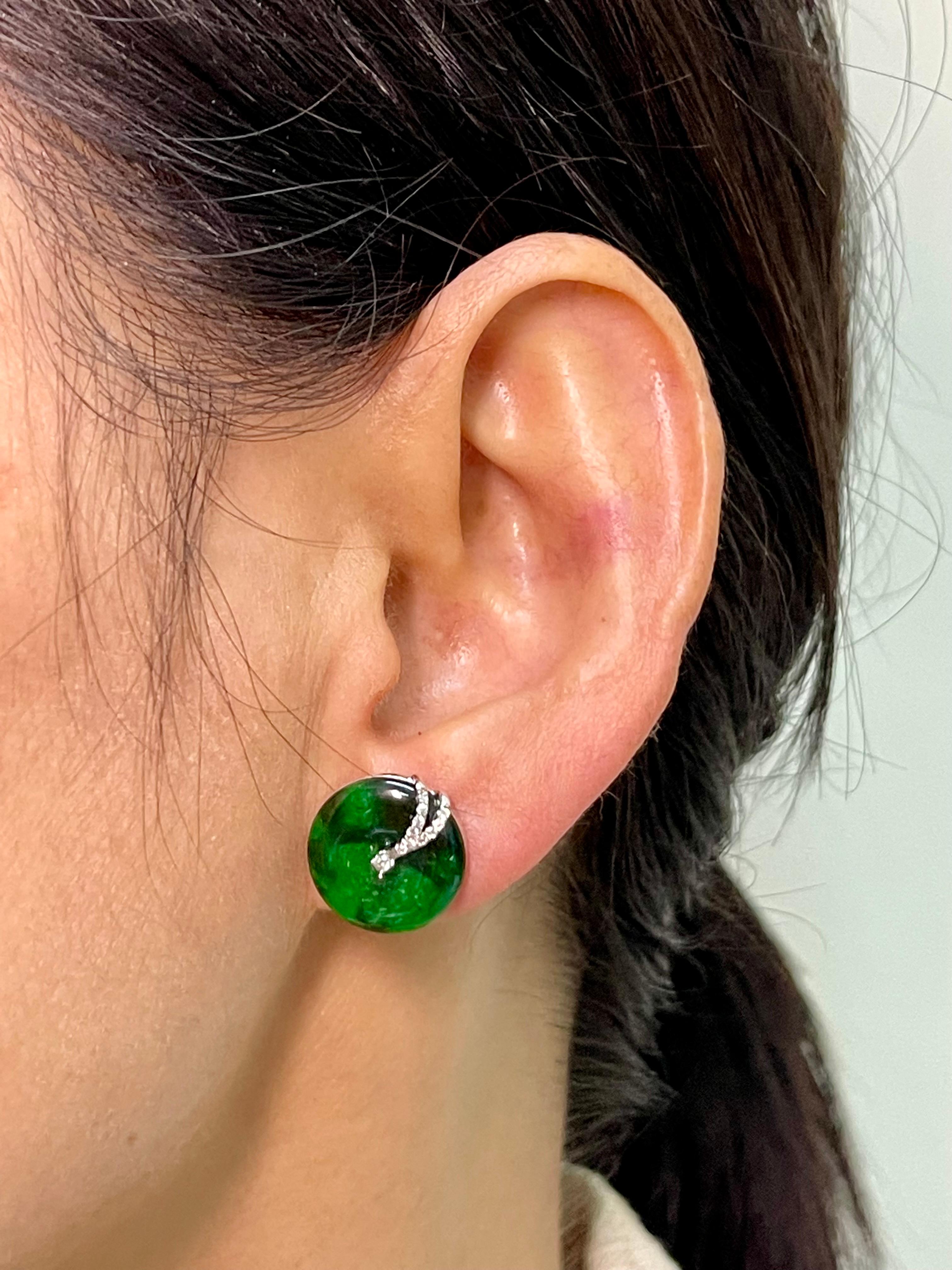 Please out the HD video! Here is a nice pair of spinach green Jade earrings. The diameter of the earrings are about 14.5mm each. The earrings are set in 18k white gold and diamonds. There are white diamonds totaling 0.133cts in this setting. The