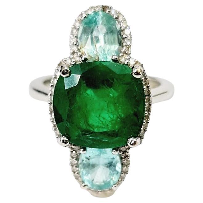 Certified 6.47 Carat Emerald, 1.96 Carat Paraiba and Diamond Three-Stone Ring For Sale