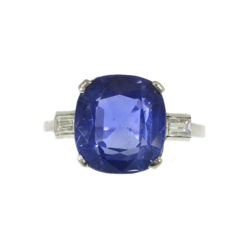 An engagement ring in platinum, French hallmarks, set with one certified cushion cut untreated sapphire weighing 6.8 carat and two baguette cut diamonds (colour and clarity: G/I, si/i). Ring size 6¼, can be sized.