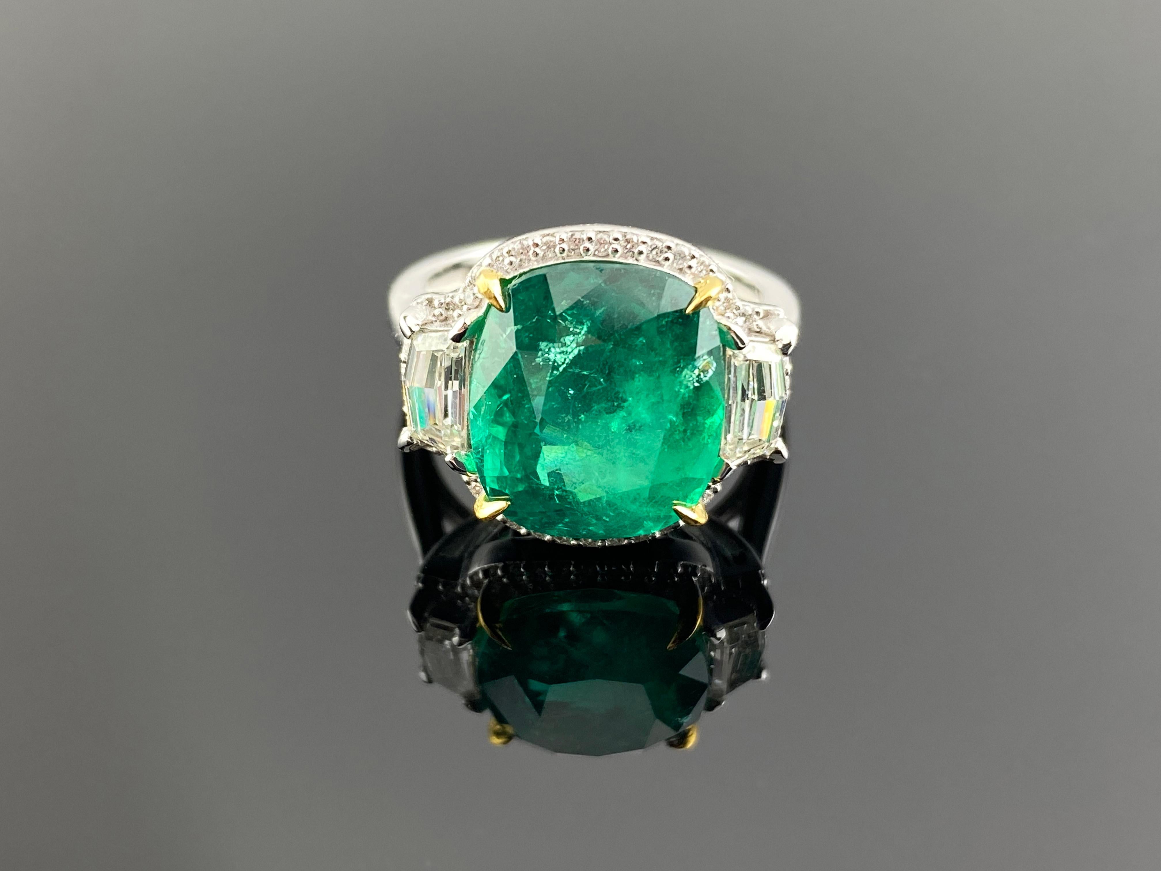 A stunning ring featuring a 7.32 Carat Natural Colombian, Vivid Green Cushion Cut Emerald , 2 G - VS Cadilac shaped diamonds weighing a total of 0.60, along with 0.18 Carats of Diamond Accents set in 6.59 Gms 18K Gold. People have admired emerald’s