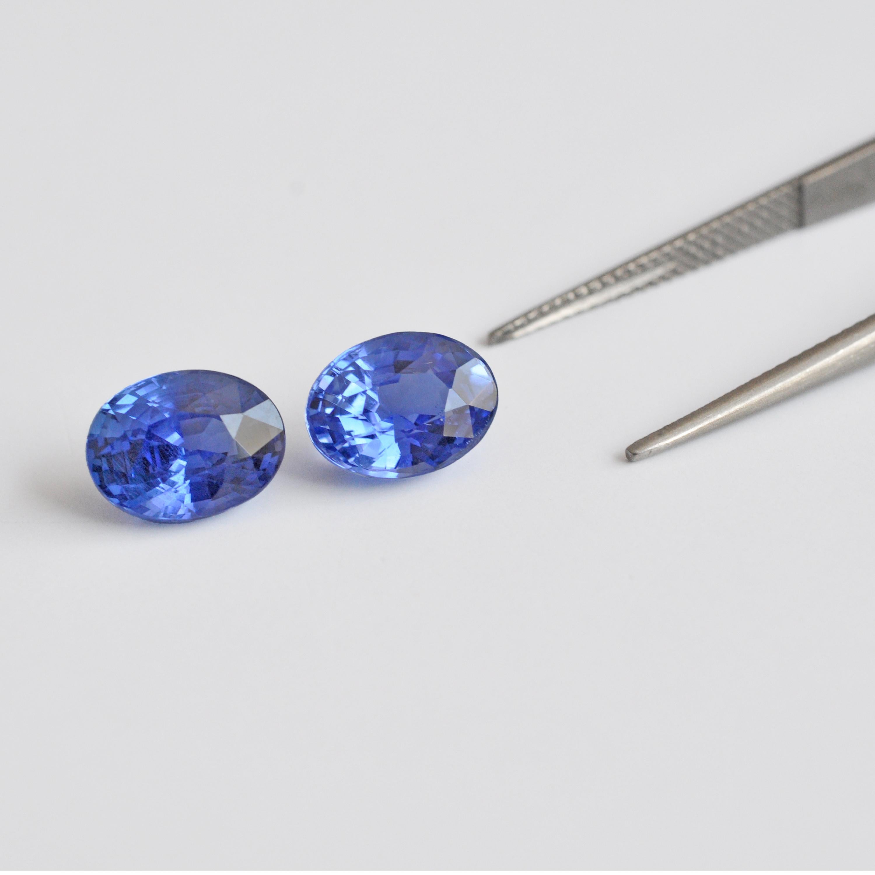 Prepare to be enchanted by a rare and exquisite pair of Natural Unheated Ceylon Blue Sapphire Gemstones, each meticulously crafted into an oval cut, creating a perfectly matched pair totaling 7.76 carats. The first gemstone weighs 3.90 carats and