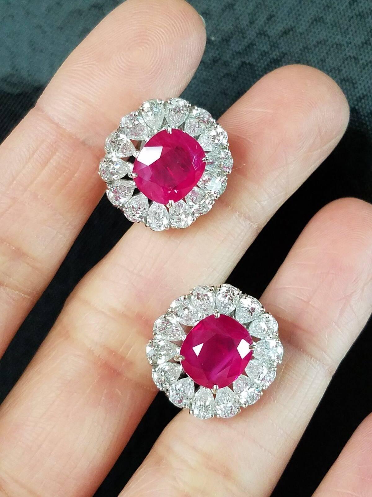 A beautiful pair of classic, oval cut heated Burma Ruby stud earrings, set in 18K white gold with pear shaped diamonds sorrounding the centre stone, with an omega backing.

Stone Details: 
Stone: Burma Ruby
Carat Weight: 8.11 Carats

Diamond