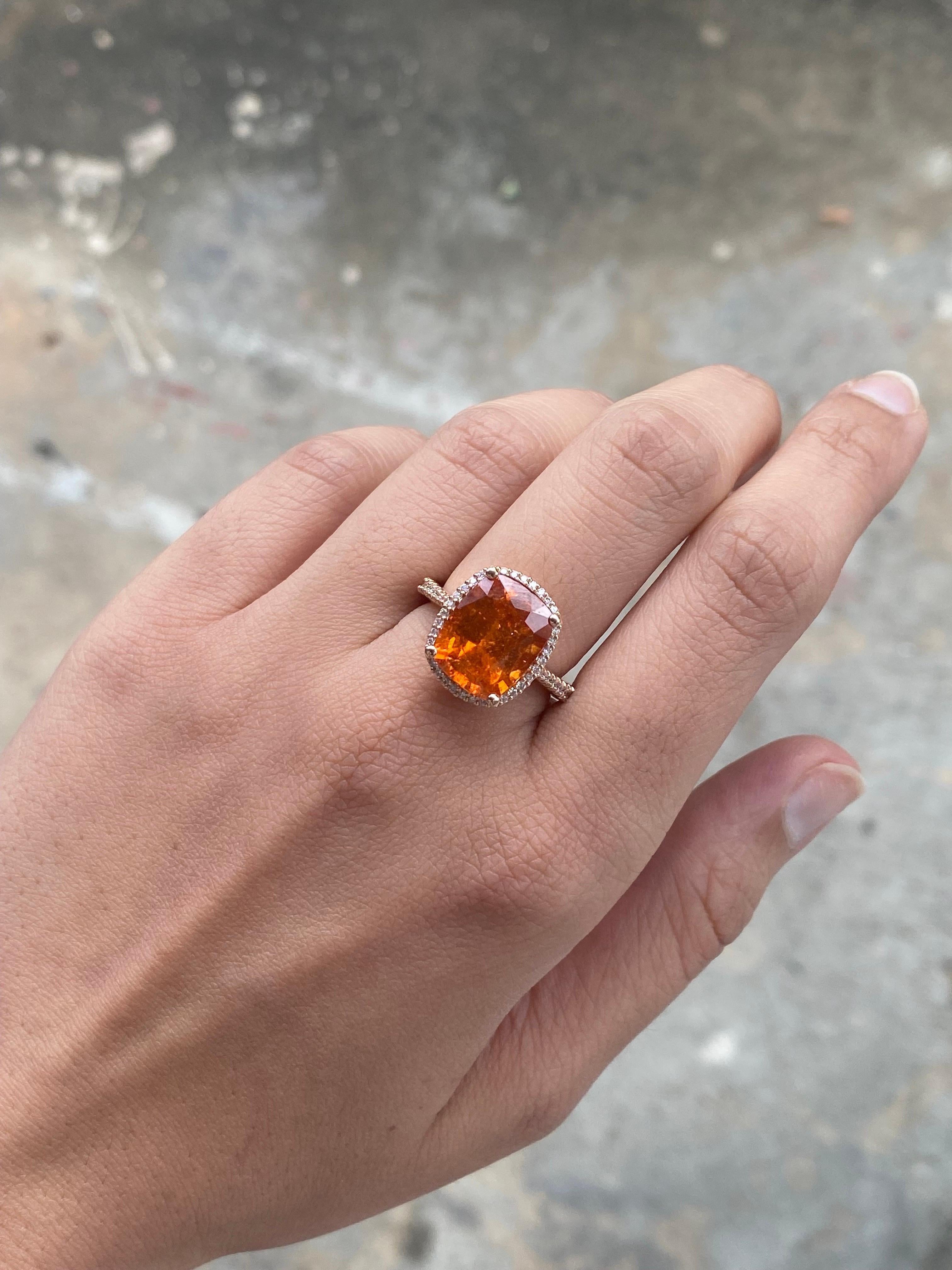 A beautiful natural 8.20 Carat Mandarin Garnet Spessartine centre stone, with a White Diamond halo, all set in solid 18K Rose Gold. The Mandarin Garnet is transparent, with few naturally occuring inclusions, vivd orange color and great luster. The