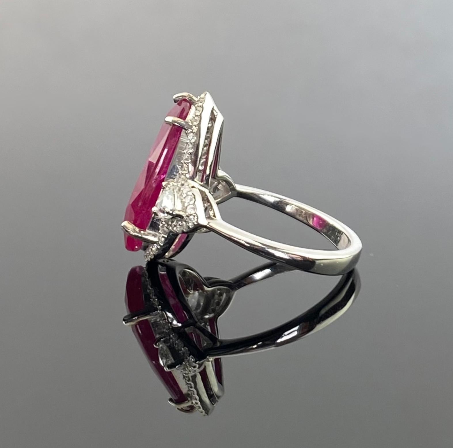 A stunning 8.8 carat certified natural, Burma Ruby, vivid red color and transparent. The center piece is adorned with 0.38 carat pear shape side stone Diamonds, VS quality, G color, and 0.30 carat round diamonds. The ring is currently sized at US 7,