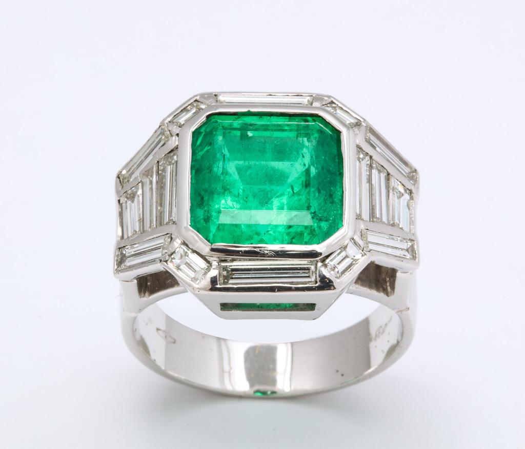 Very fine Colombian emerald (app. 9carats) surrounded by baguette diamonds (app. 3carats) in a beautifully made Italian ring.  The spectacular cutting and the wonderful shape truly bring out the brightest vivid green in this superb gem.  Colombian
