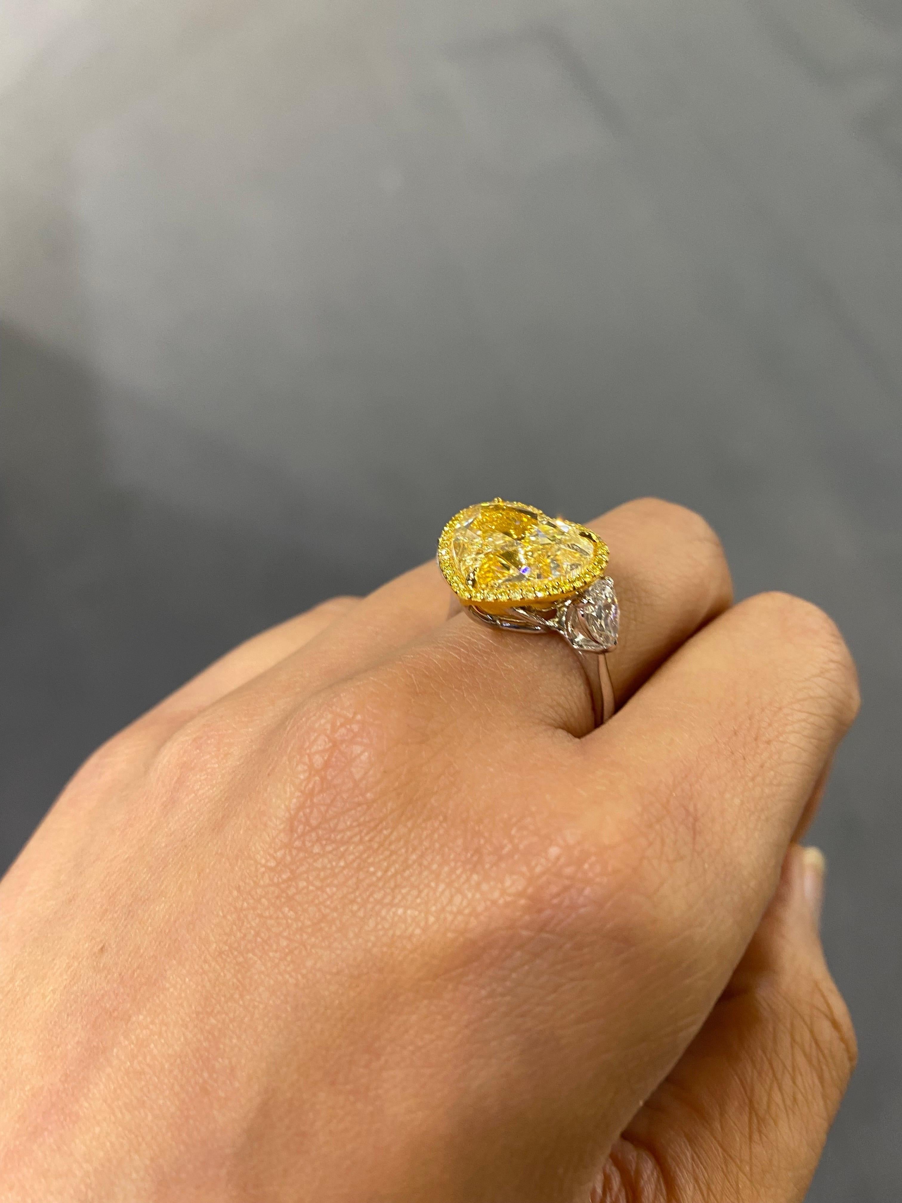 A certified, stunning heart-shaped 9 carat natural YZ Yellow Diamond ring, SI1 quality, with 2 pear shape white diamonds on the side. The ring is currently sized at US 7, can be resized.
Please feel free to message us for more information. 