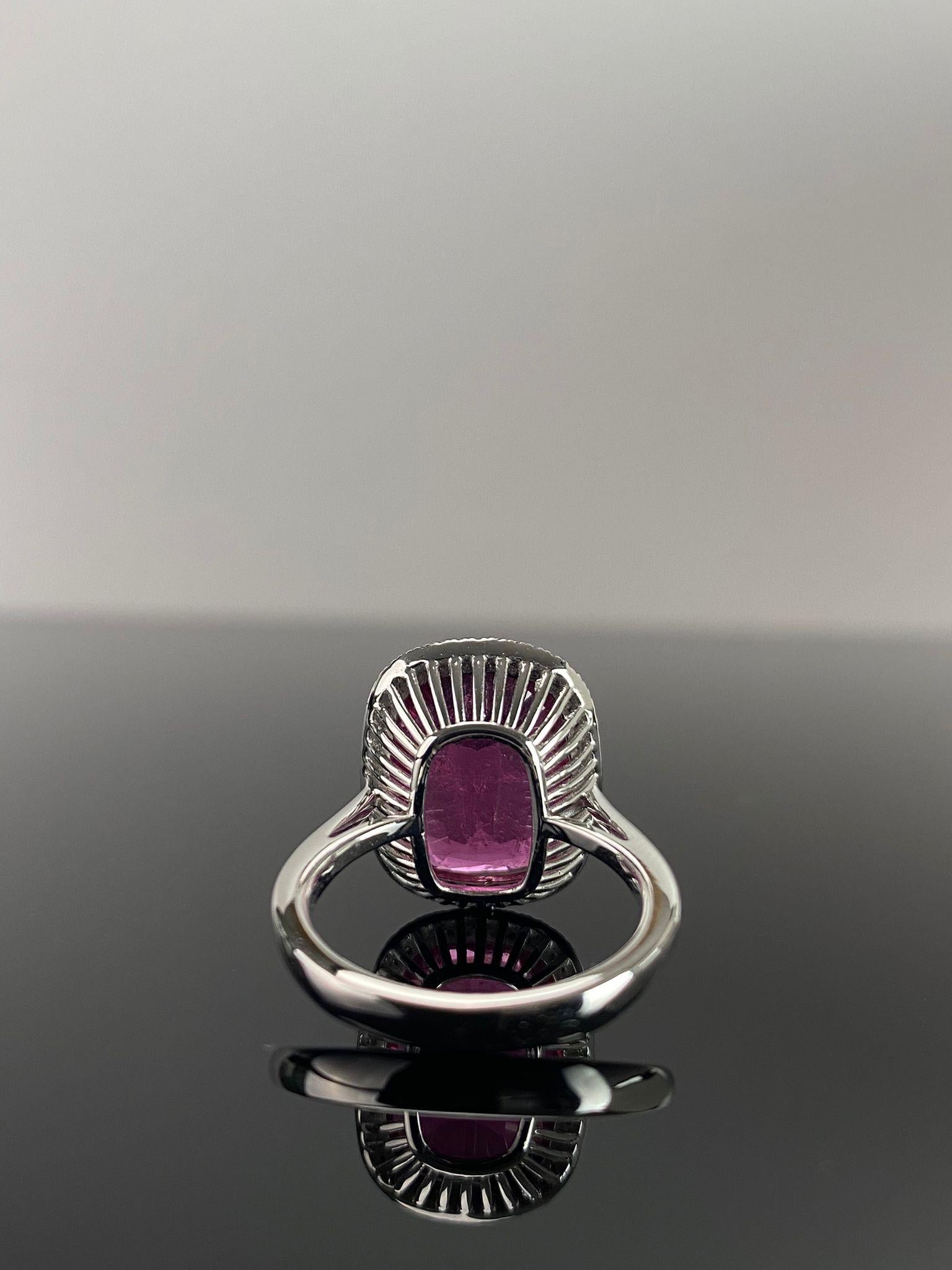 A beautiful 9.40 carat cushion shaped, reddish-pink Rubelite Tourmaline center stone, with 0.24 carat White Diamonds surrounding it. The center stone is transparent and has a very ideal pink color, and great luster. The stones are set in solid 18K