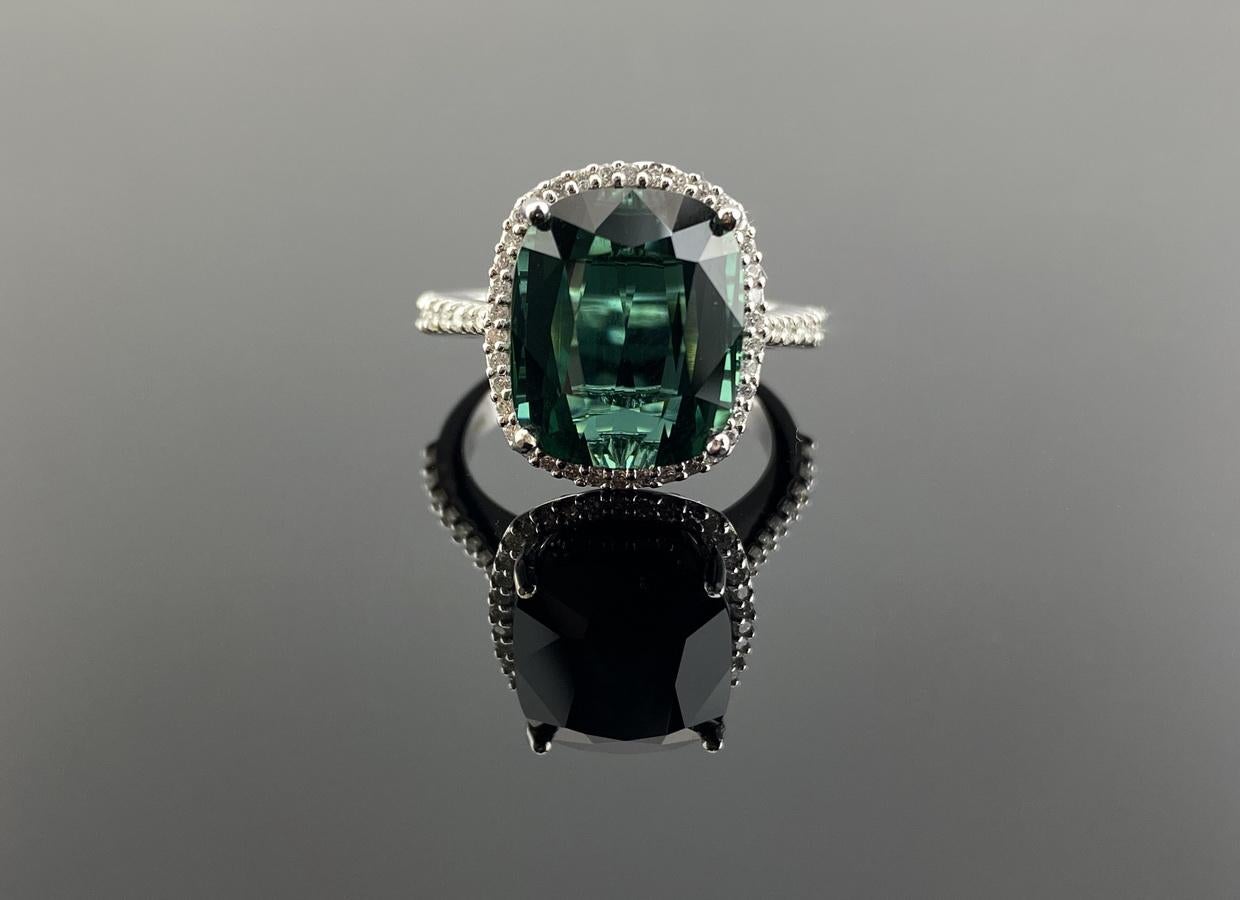 A beautiful green colored natural Tourmaline engagement ring, with White Diamond halo around it - set in solid 18K White Gold. 
The tourmaline weights 9.41 carat with 0.51 carat Diamonds, and the center stone is absolutely transparent with no