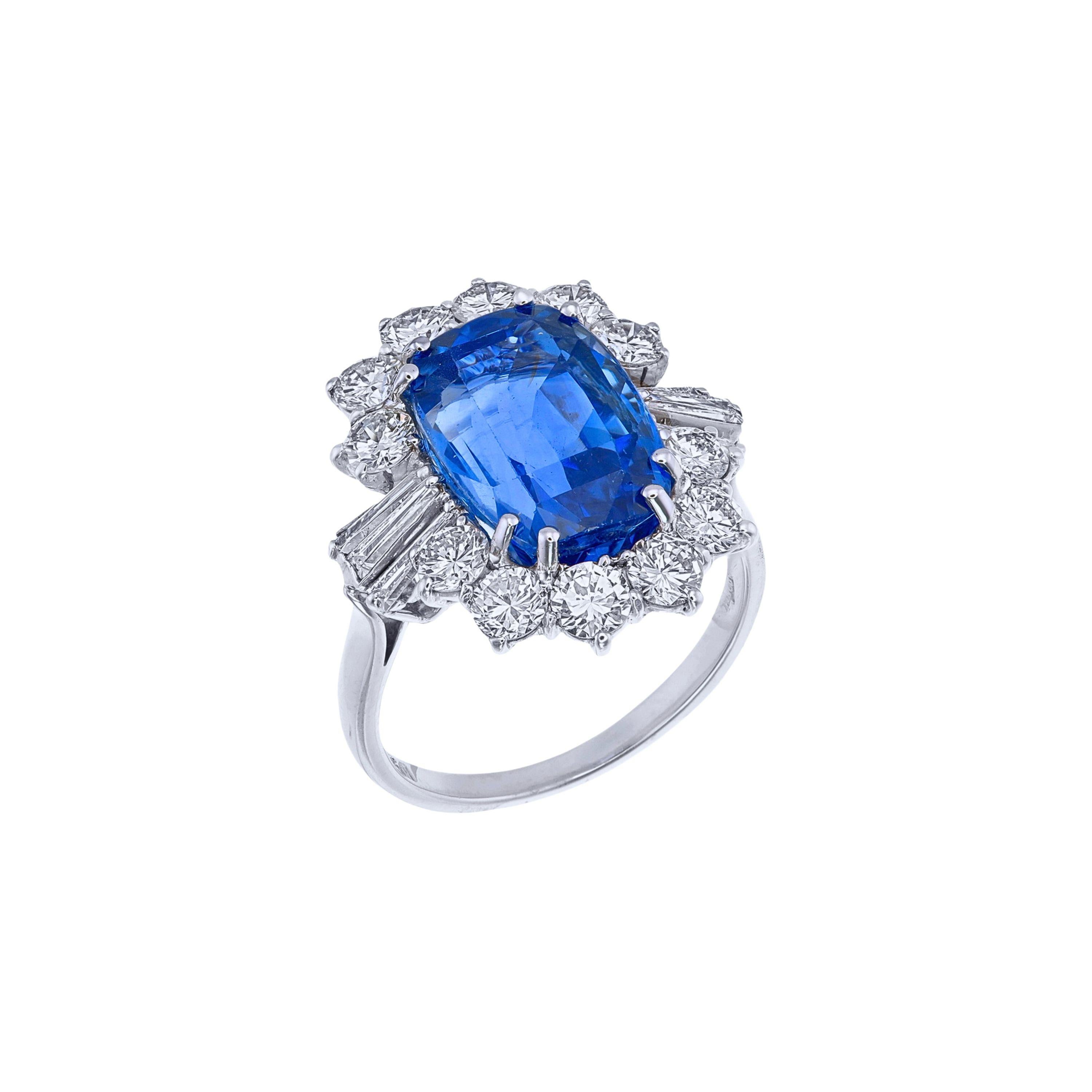 Experience luxury and sophistication with this extraordinary statement ring, featuring a breathtaking 9.43-carat cushion-cut sapphire at its center. With its striking brilliance and mesmerizing hue, this exquisite vivid blue sapphire has undergone