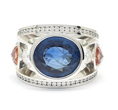 Certified 9.45 Carat Intense Blue Sapphire 2 Orange Corunds and 56 Diamonds Ring