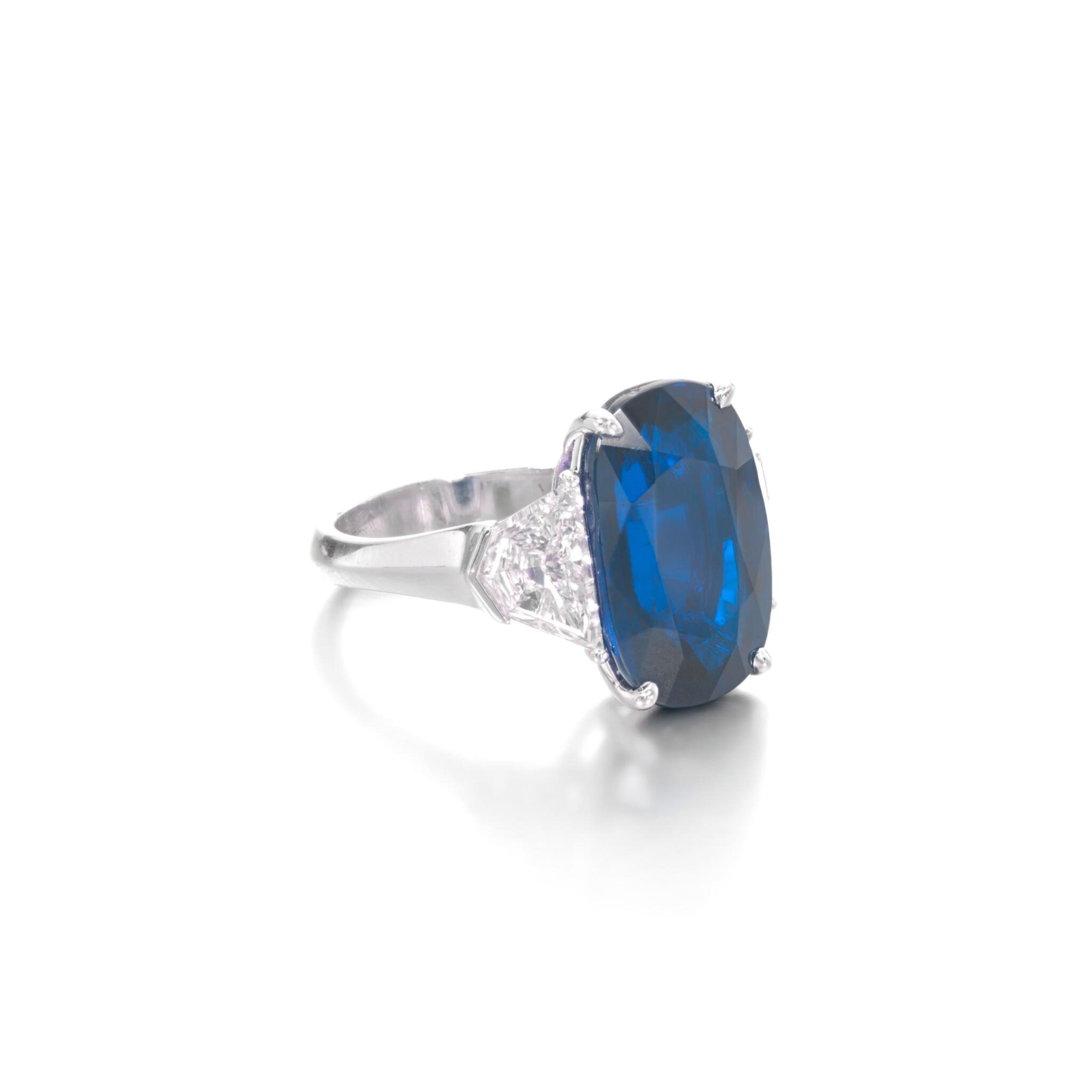 Centering an oval-shaped sapphire, flanked by 9.68 halfmoon-shaped diamonds, decorated throughout with round diamonds.

blue sapphire weighing 9.68 carats
Size 6
Platinum

