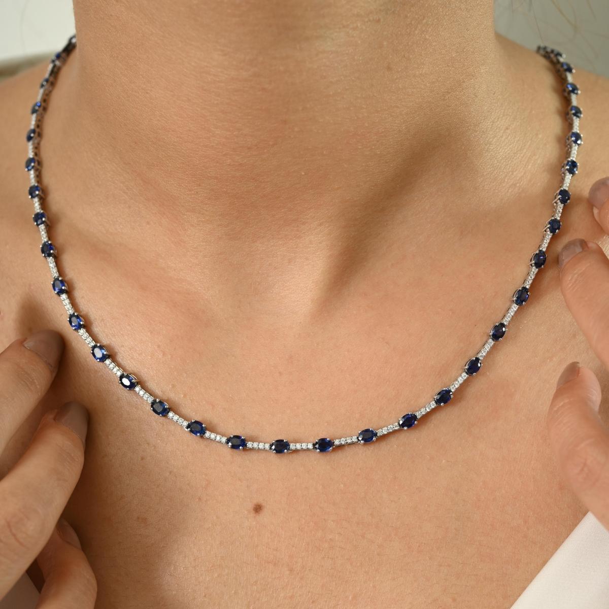 Make a statement with this exquisite necklace, crafted in luminous 14k white gold. Featuring a stunning arrangement of deep blue gemstones with a total stone weight of 9.9 carats, this piece radiates sophistication and timeless charm. Each gem is