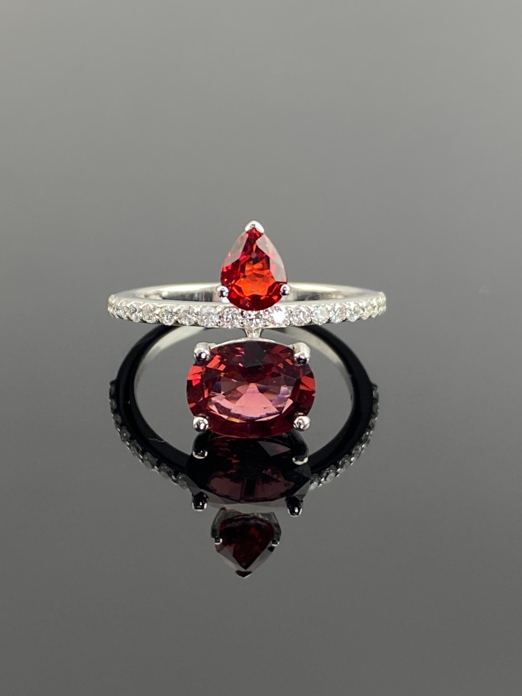 The ring's design is centered around a natural pear-shaped ruby from Songea, measuring 6 x 4 mm and weighing 0.73 carats. This ruby has been carefully heated to enhance its vibrant red color, making it a perfect complement to the natural oval-cut