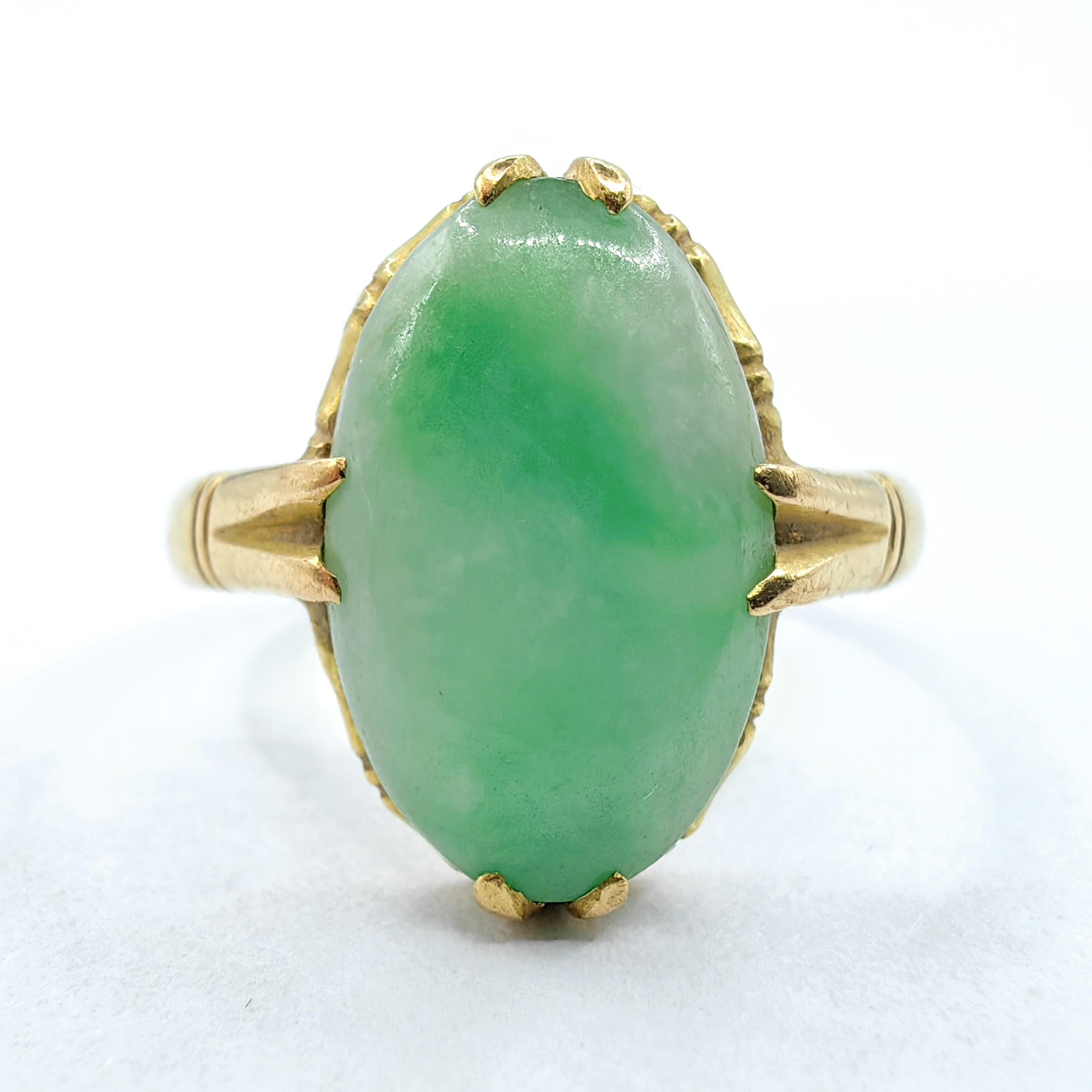 This exquisite antique ring showcases a certified genuine Burmese jadeite jade cabochon, displaying the highly sought-after 
