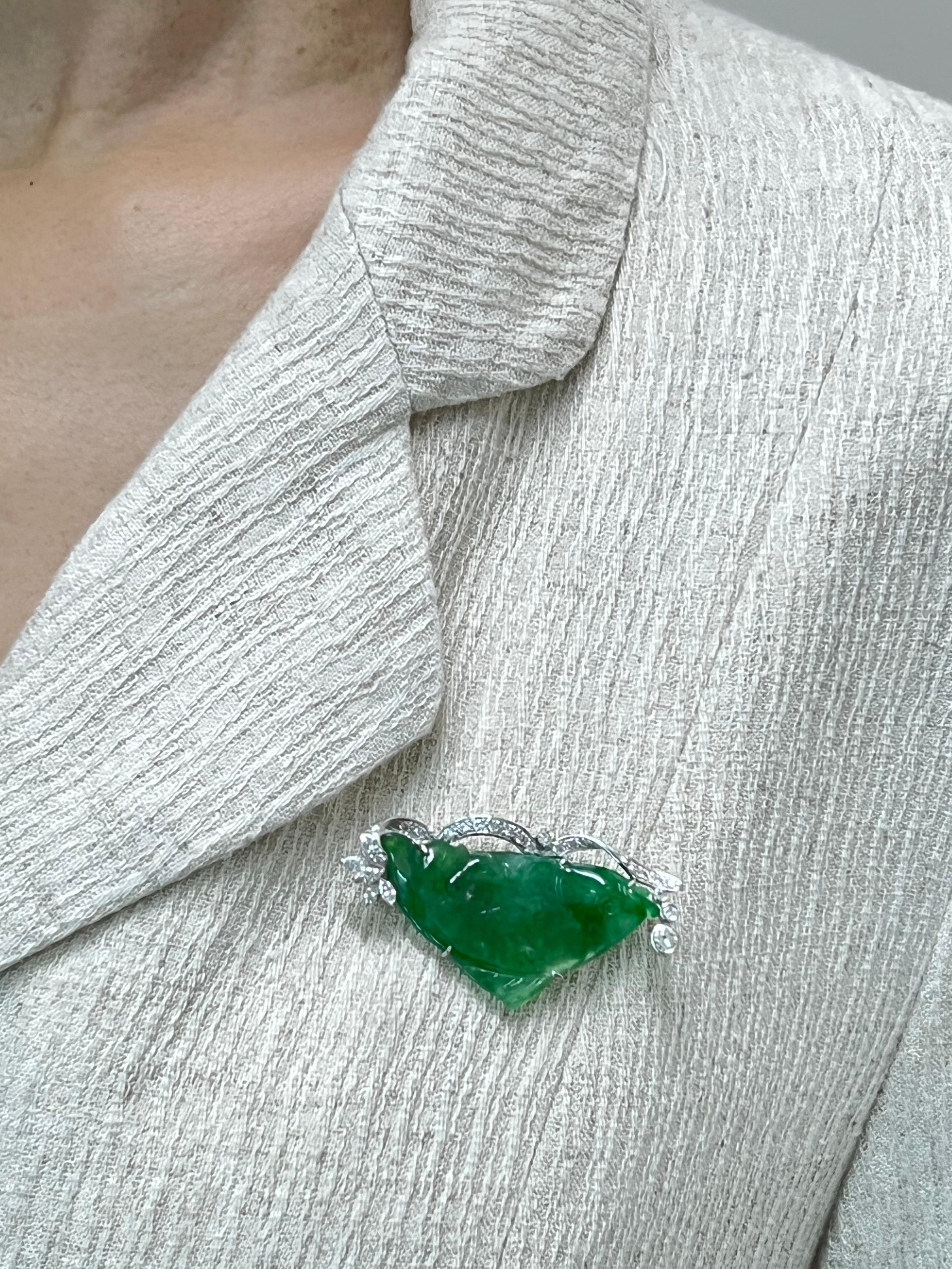Please check out the HD video. This apple green jadeite jade brooch is large in surface area! This is certified to be natural jadeite jade. The brooch is set in 18k white gold. There is one large carved fish green jade and 4 marquise white diamonds