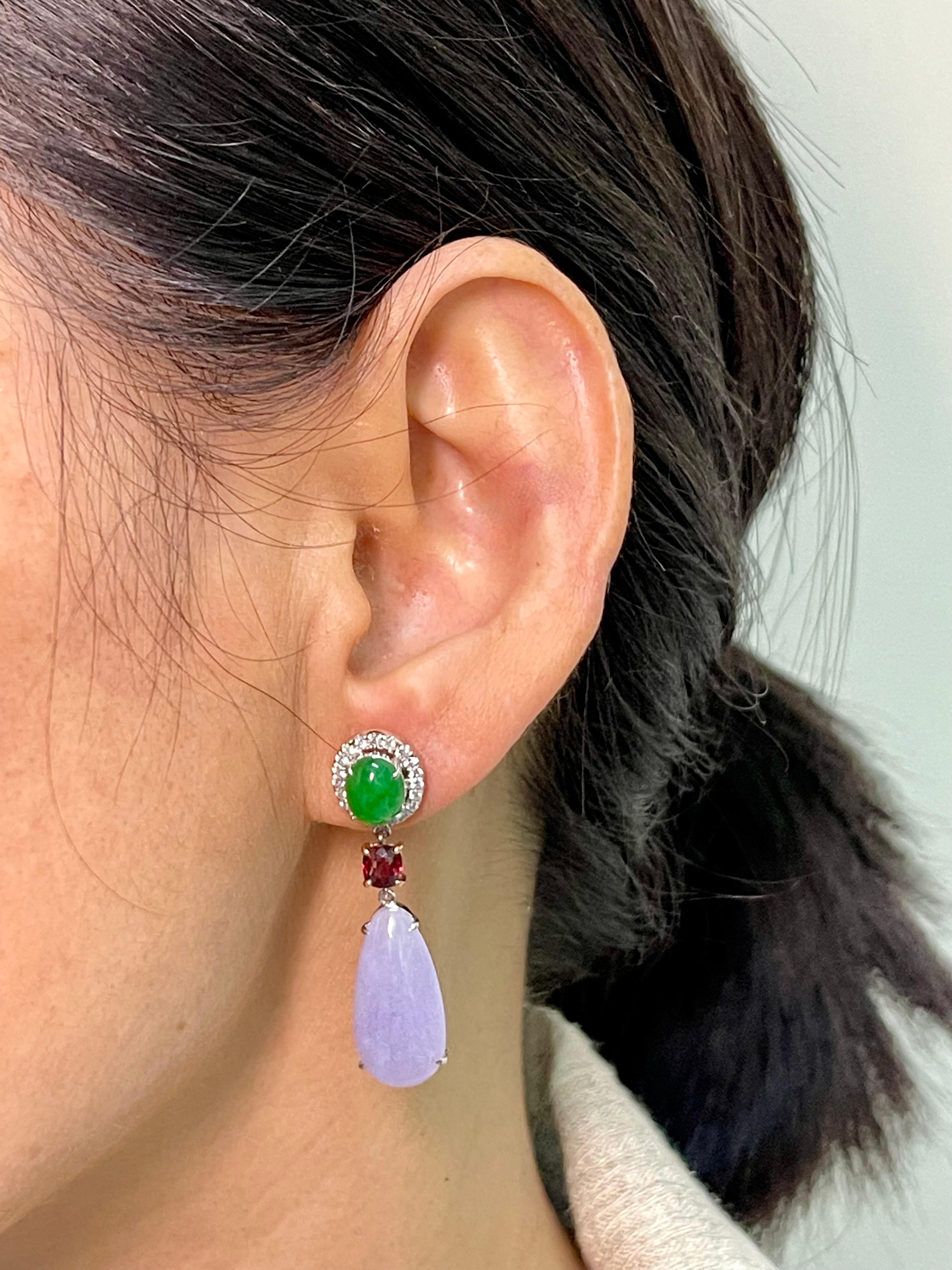 Please check out the HD video. All 4 pieces of jade are certified. These colorful earrings are set in 18k white and rose gold. Starting form the top are 2 apple green jade cabochons (3.35cts) with a halo of diamonds, follow by 2 vivid red spinels