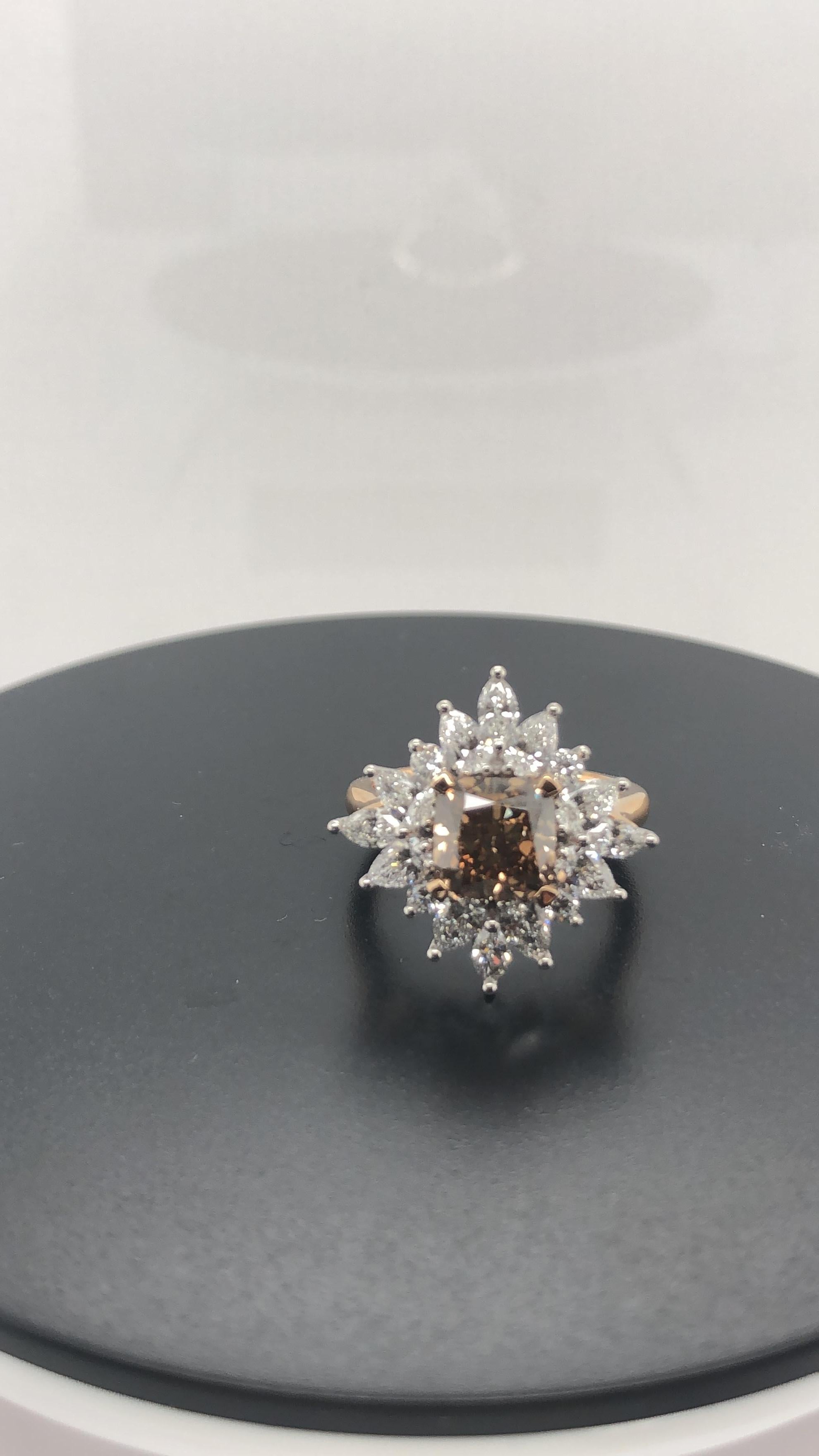 Hand made 18 carat rose and white gold Engagement ring, set with a Certified Argyle Cushion cut 2.53 carat Champagne Diamond C5, VS in clarity as per Origin Report # RTARG101867, surrounded by 16 claw set Round Brilliant cut, Pear and Marquise