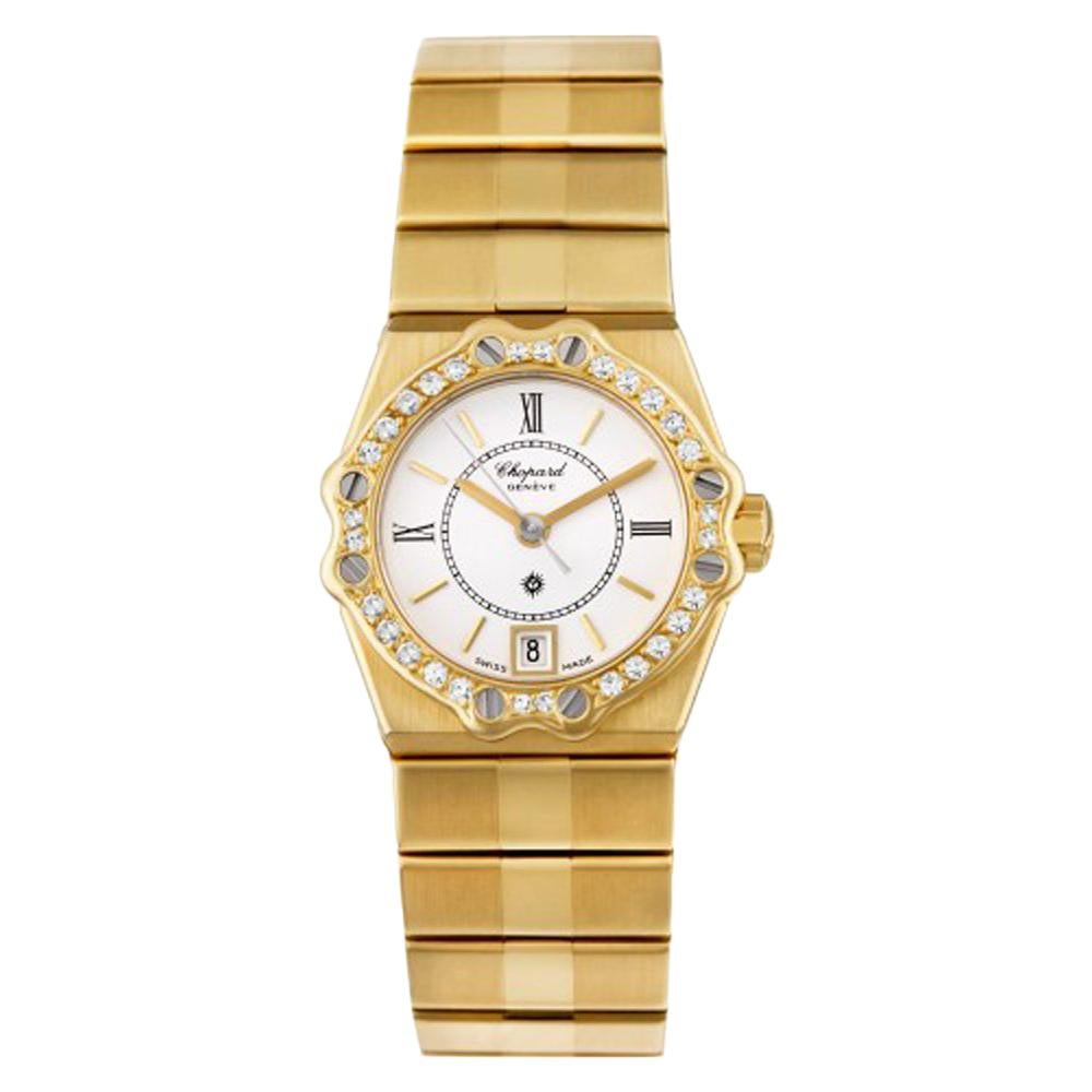 Chopard St Moritz Reference #:5156. 18K yellow gold case with 18K yellow gold bracelet. Fixed 18k yellow gold bezel with diamonds and screws. White dial with gold-tone hands and Roman Numeral hour and stick hour markers. Minute markers around the