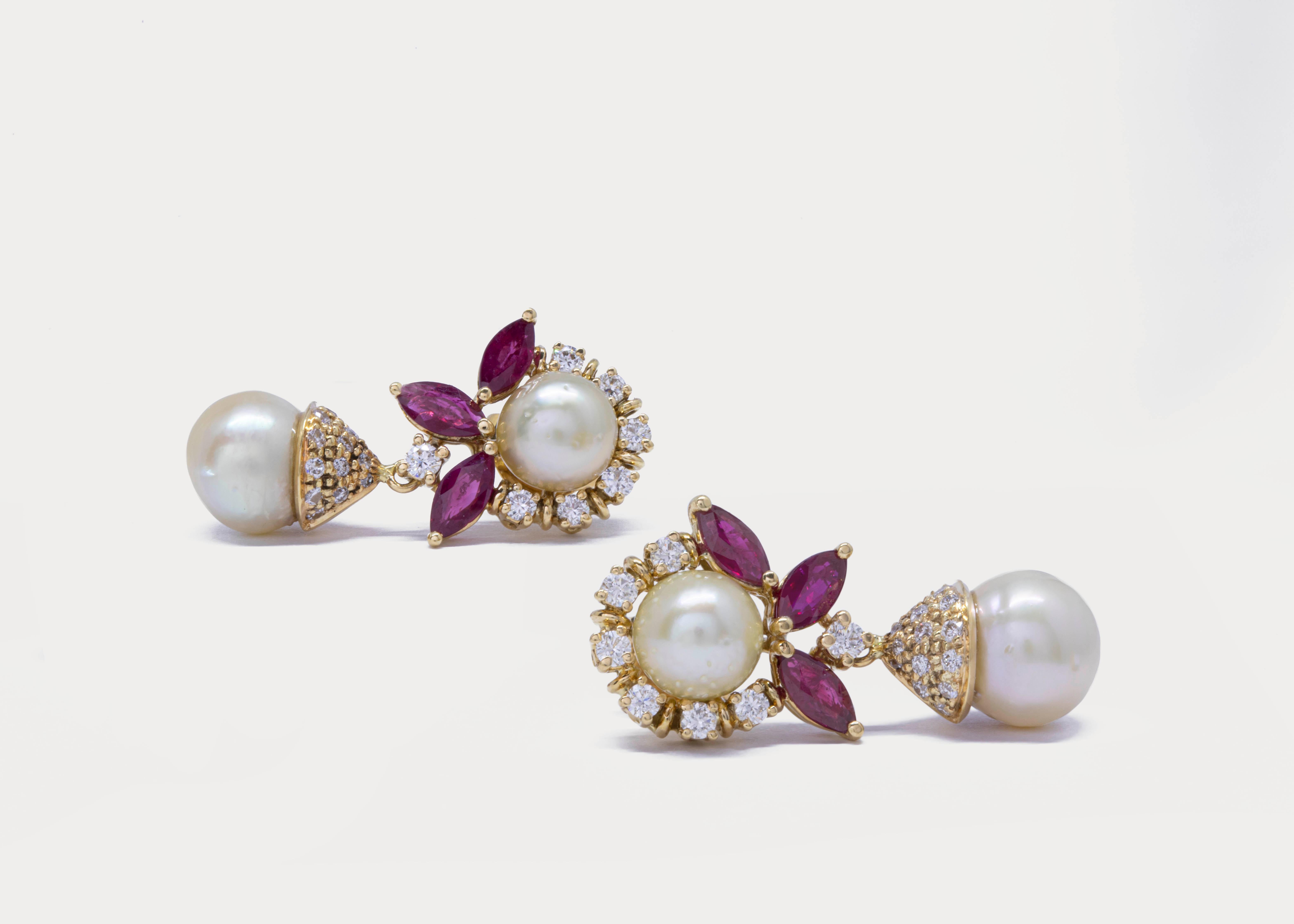 Simple sophistication...

Natural Bahraini drops and buttons pearls are the center of attention in those 18k yellow gold earrings.
The cream pearls are surrounded by VS1 diamonds and marquise rubies.

Gold Weight: 6 g
Pearl Weight: 12.2 ct.
Diamond