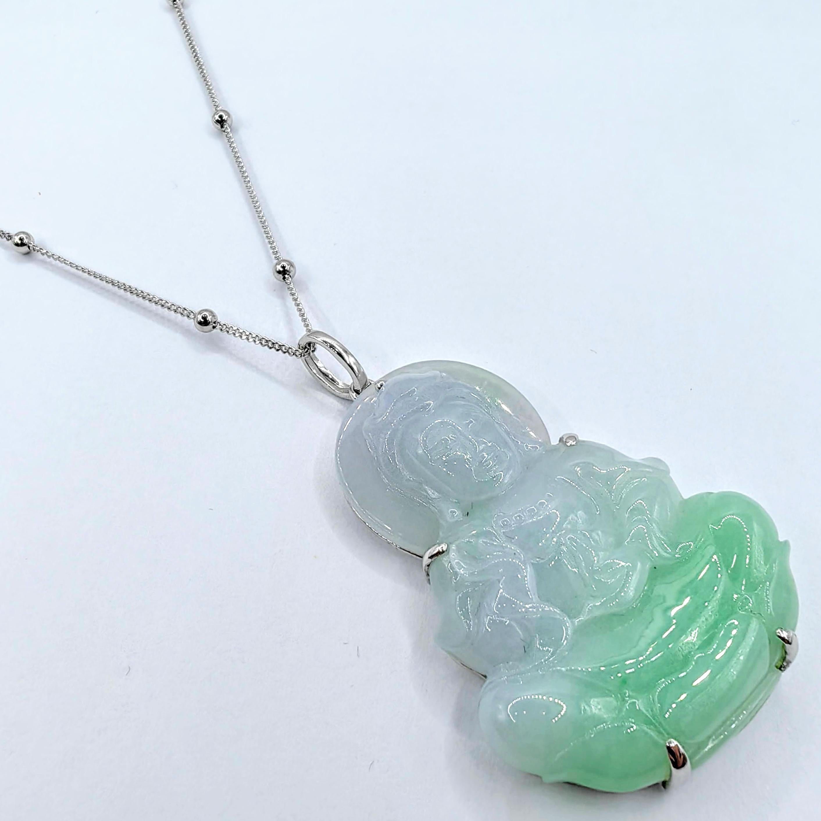 Discover a spiritual masterpiece in this Certified Bi-Color Green Jadeite Jade Kwan Yin Buddha Pendant, set in luxurious 18K white gold. Skillfully carved from a single piece of pale green to vibrant green jadeite jade, this pendant portrays the