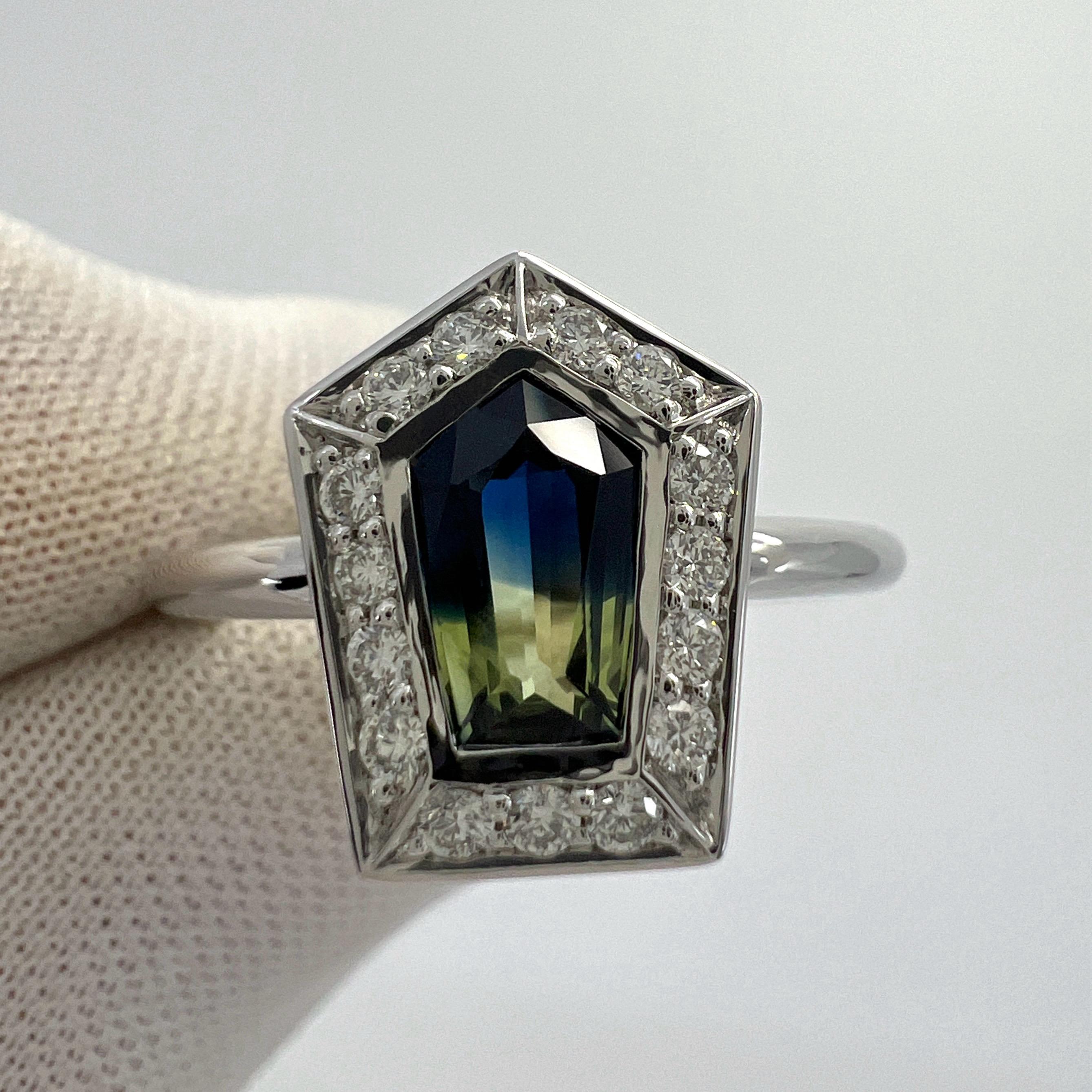 Unique Natural Blue And Yellow Bi Colour Fancy Pentagon Cut Sapphire And Diamond 18k White Gold Halo Ring. 1.17 Total Carat.

This fine ring features a beautiful 0.90 Carat centre sapphire with a unique blue and yellow bi colour effect and an