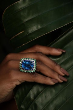 Custom Platinum Blue Topaz Cocktail Ring with Emerald and Sapphire Halo
