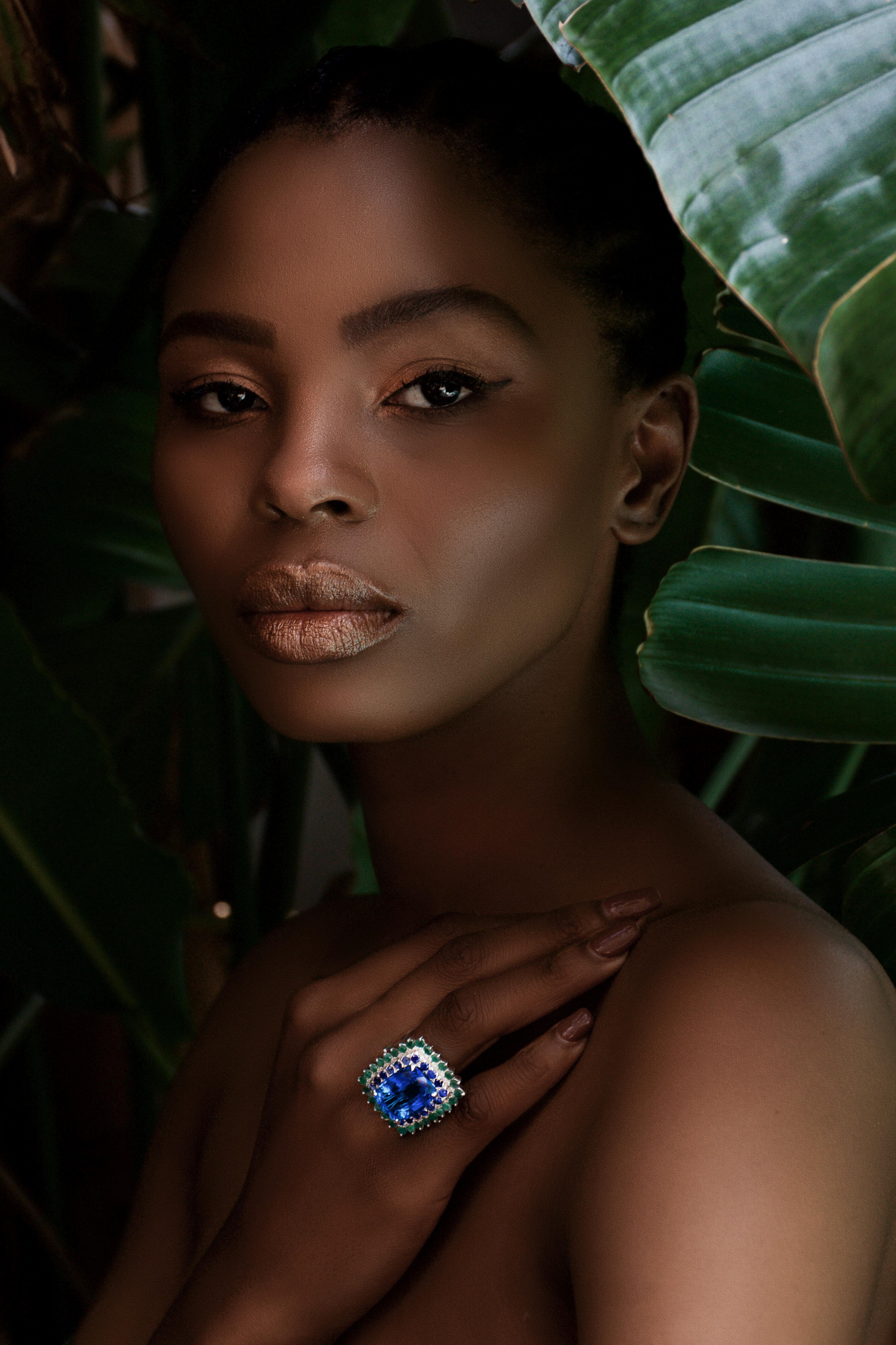 Cushion Cut Custom Platinum Blue Topaz Cocktail Ring with Emerald and Sapphire Halo For Sale
