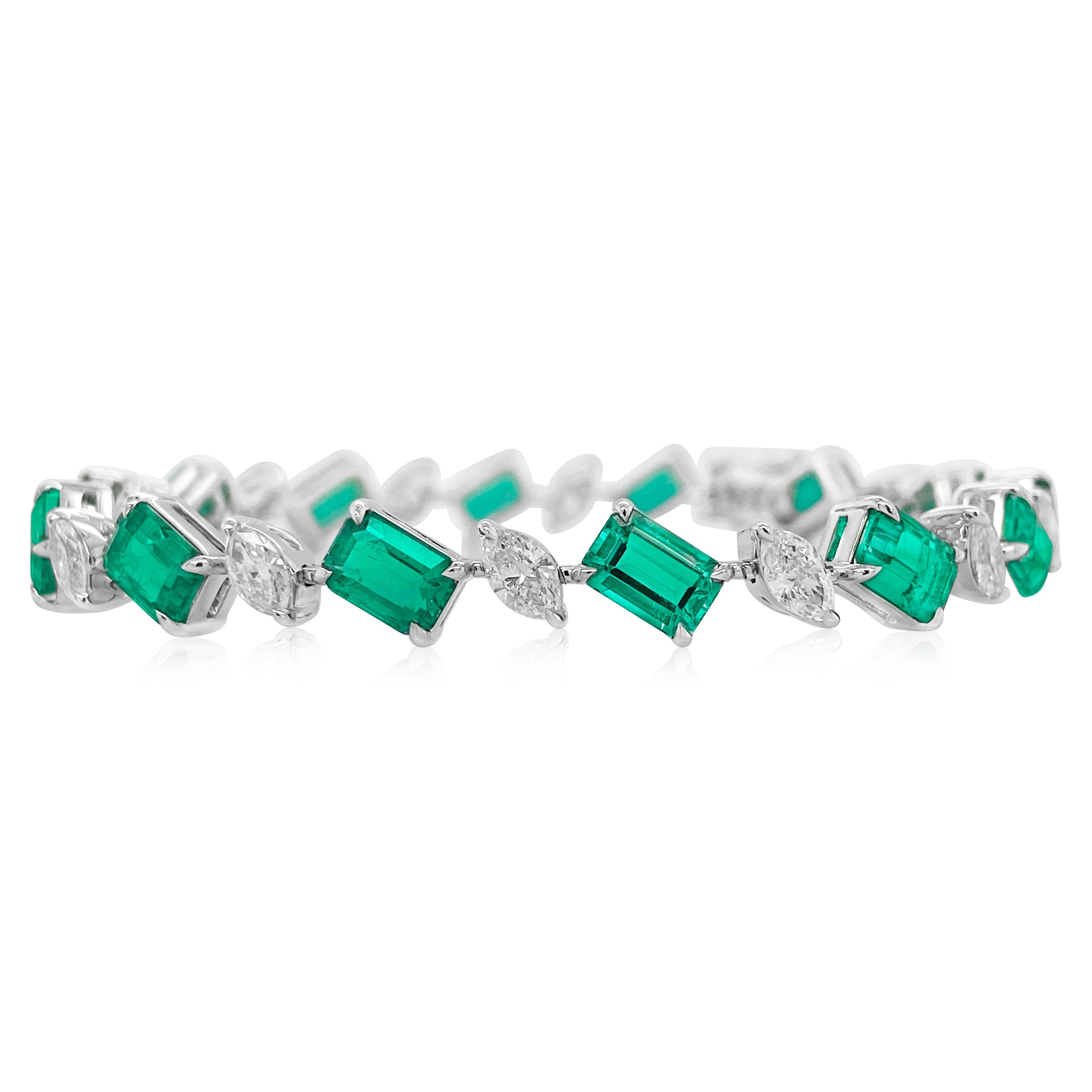 An exquisite high-jewelry bracelet featuring a certified Natural Muzo Colombian Emerald of exceptional vivd green color, elegantly set in 18K gold. The centre stone is complemented by a meticulously arranged suite of natural white marquise diamonds,