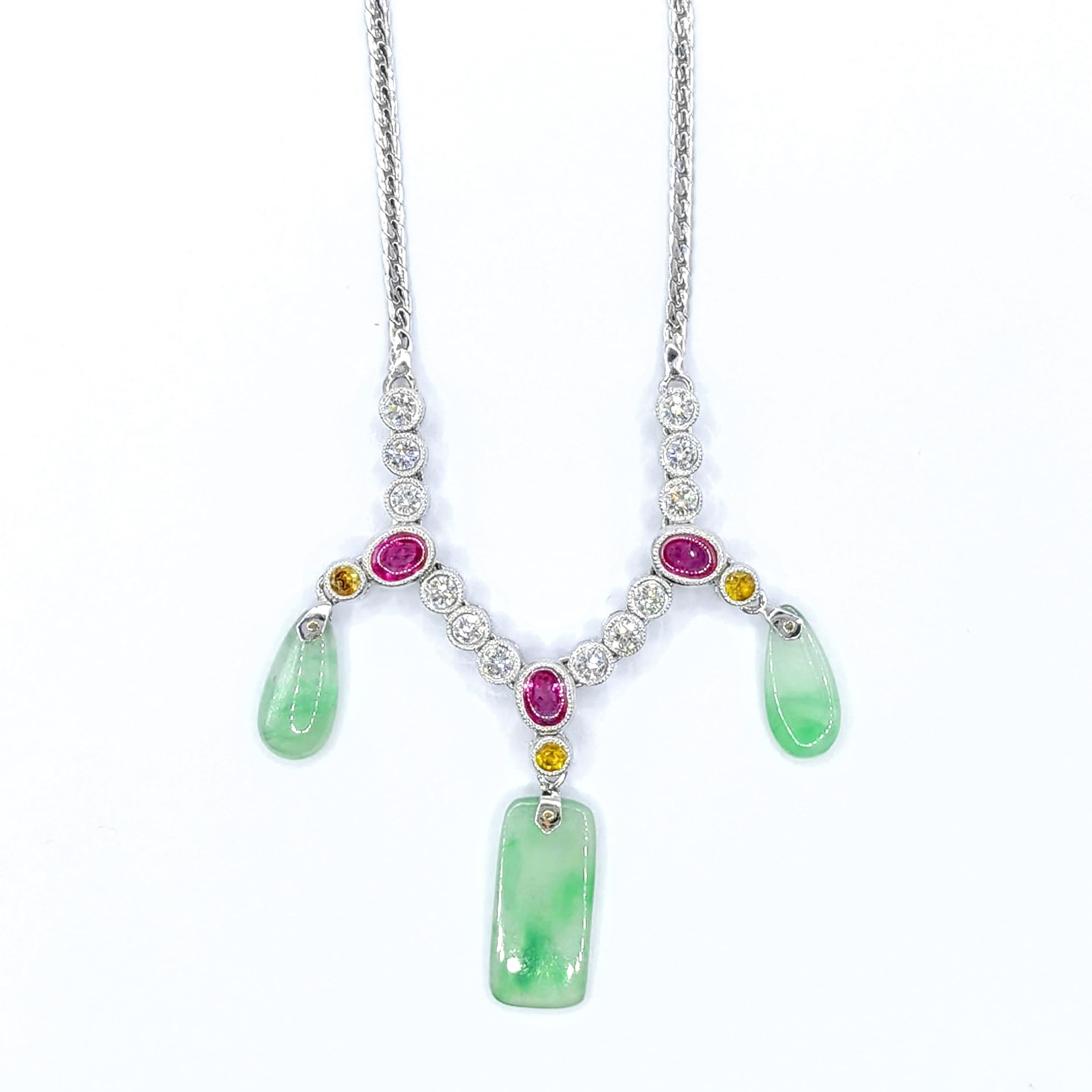 Step into a world of timeless elegance with this stunning Burmese Jade, Ruby, Yellow Sapphire & Diamond Necklace, masterfully crafted in luxurious 18K white gold. This captivating piece showcases a harmonious blend of vibrant gemstones and exquisite