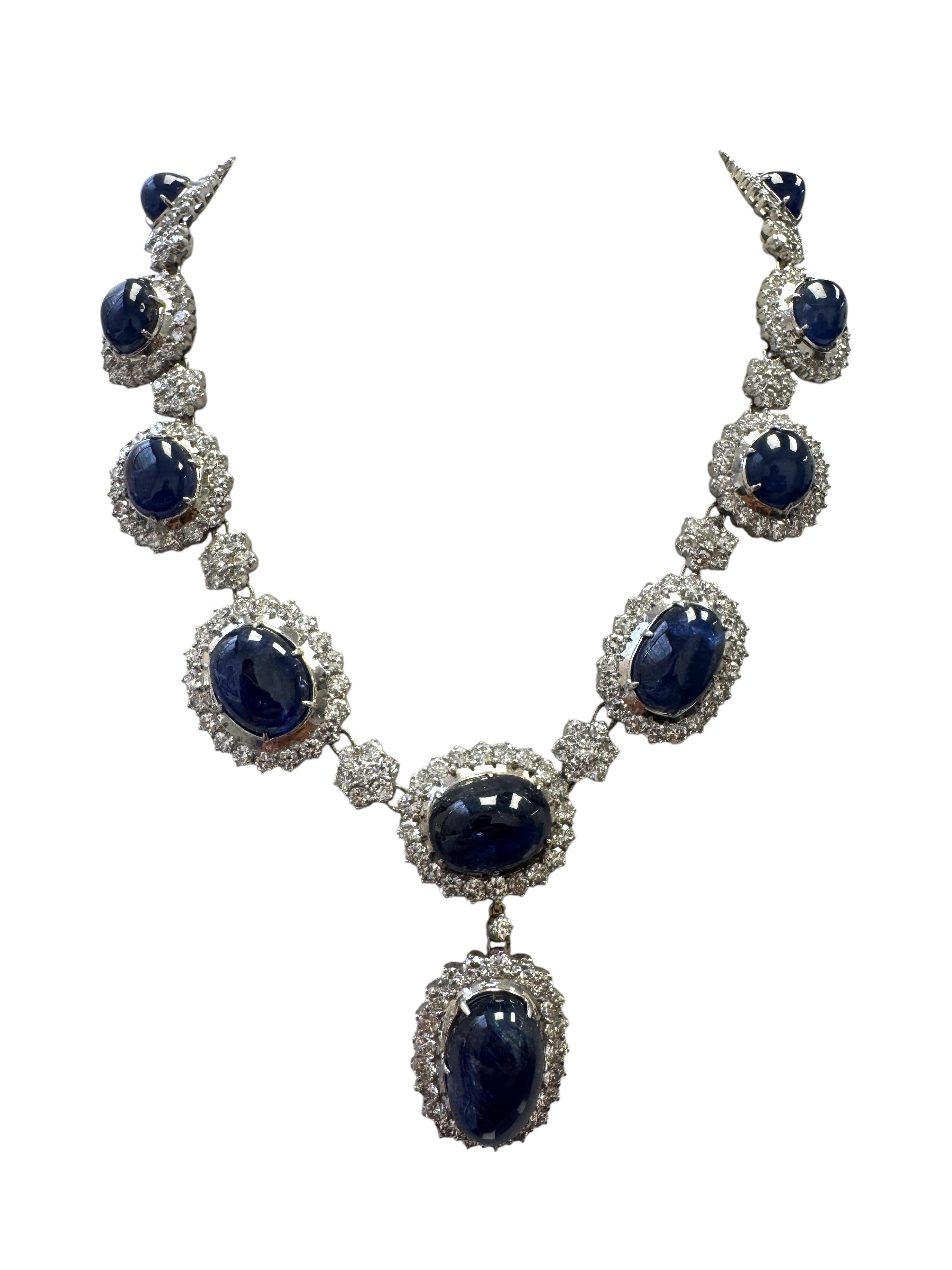 An extraordinary vintage sapphire and diamond suite, certified for its rare gem quality and fine craftsmanship. This elegant set features natural, untreated Burmese cabochon sapphires and brilliant white diamonds, all mounted in luxurious 14K white