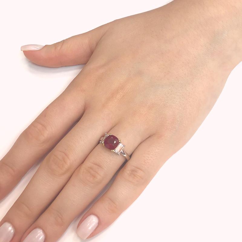 Handcrafted cocktail ring holds an oval Burmese ruby 2.48 ct center stone. 
Accented at either side by baguette cut natural diamonds 0.76 ct.
Diamonds are G-H Color Clarity VS.
Platinum 950 metal.
Width: 1.7 cm
Height: 1.7 cm
Weight: 8.8 g 