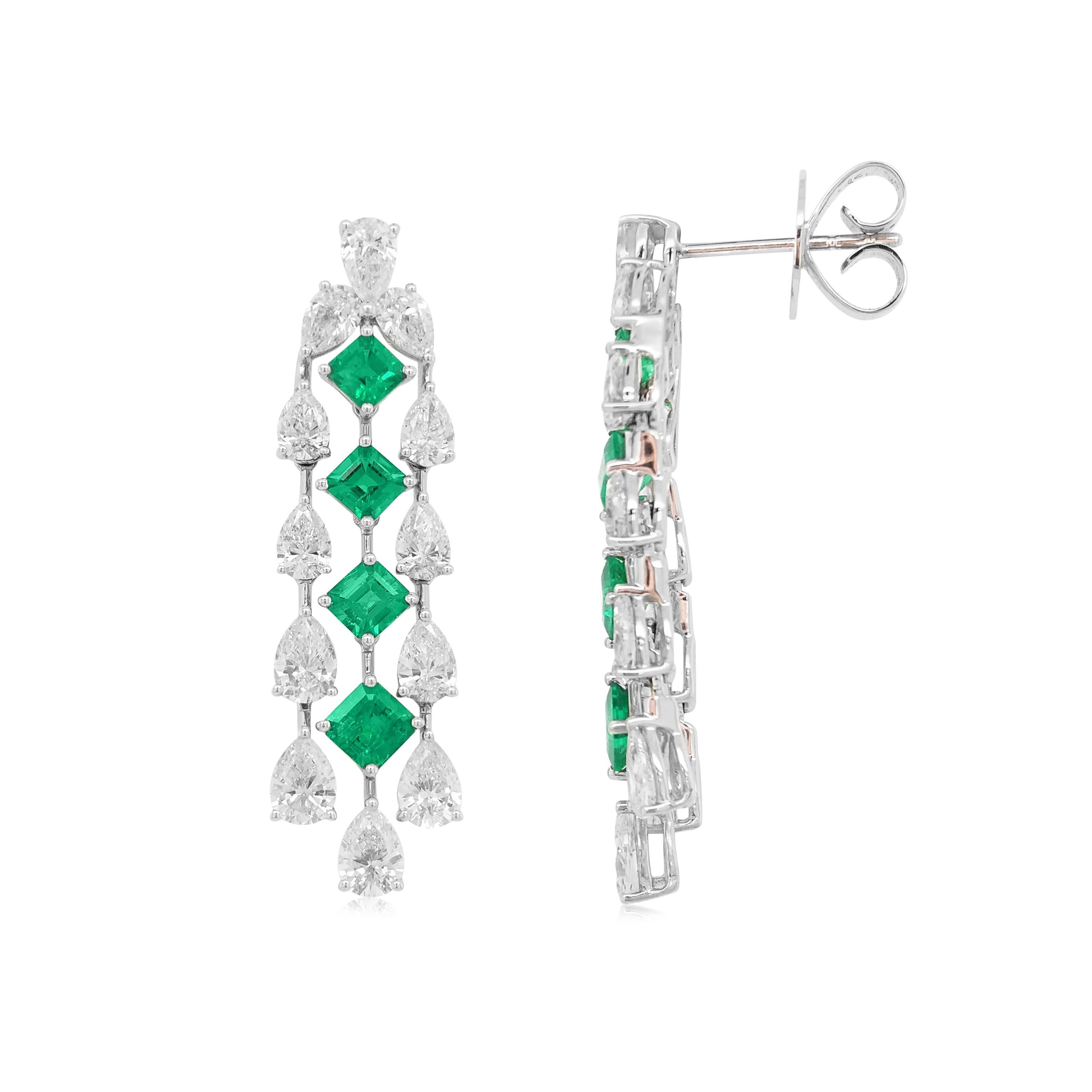 These elegant earrings feature beautiful Square-shaped Colombian Emeralds hanging with delicate streams of pear-shaped white diamonds. The 18 Karat white gold setting perfectly enriches the hue of the emerald and the bright sparkle of the diamonds.