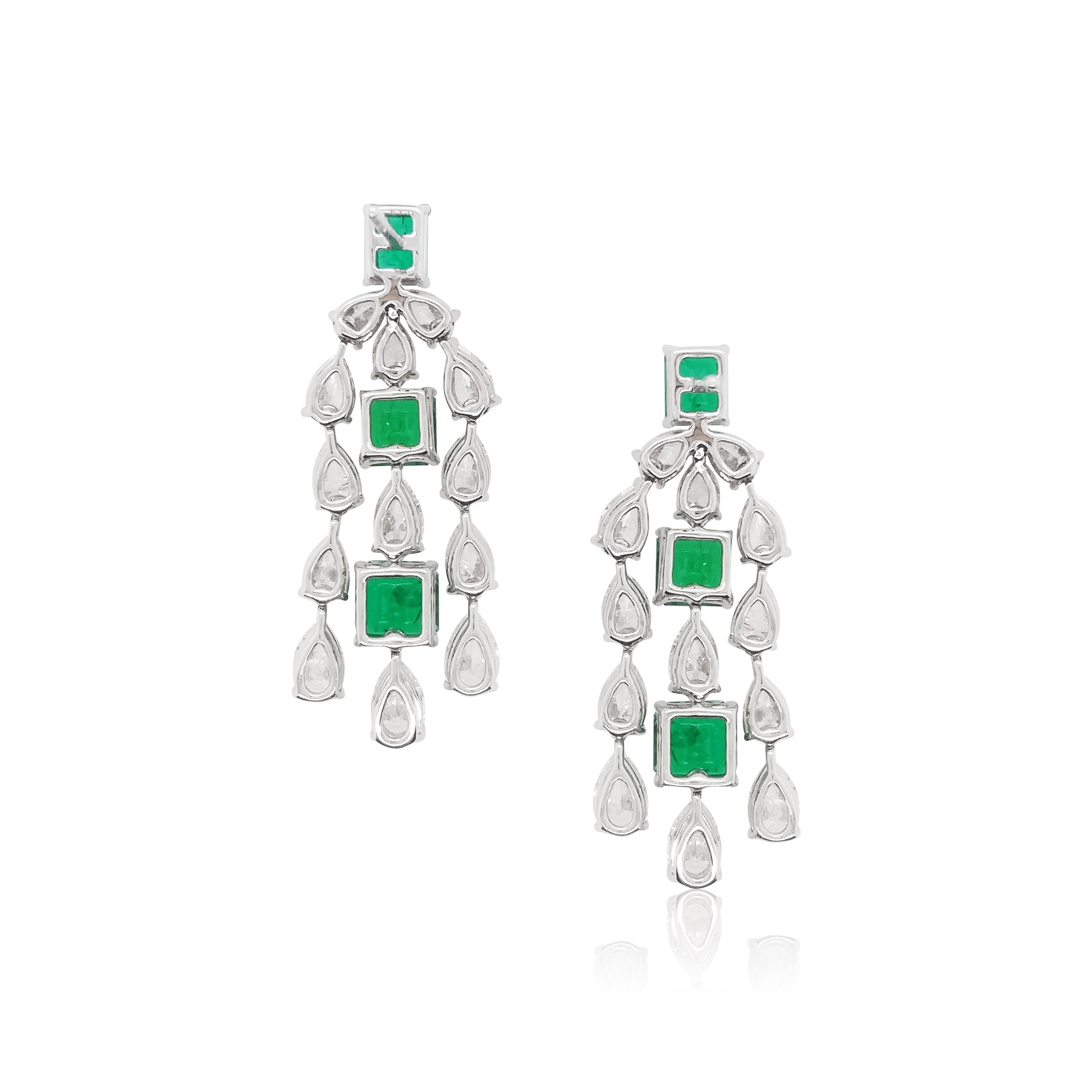 These spectacular earrings feature radiant natural Colombian Emeralds suspended beneath an alternating combination of Diamonds. Set in 18 Karat white gold to enrich the rich hues of the emeralds. Wear with any outfit that needs a striking touch of