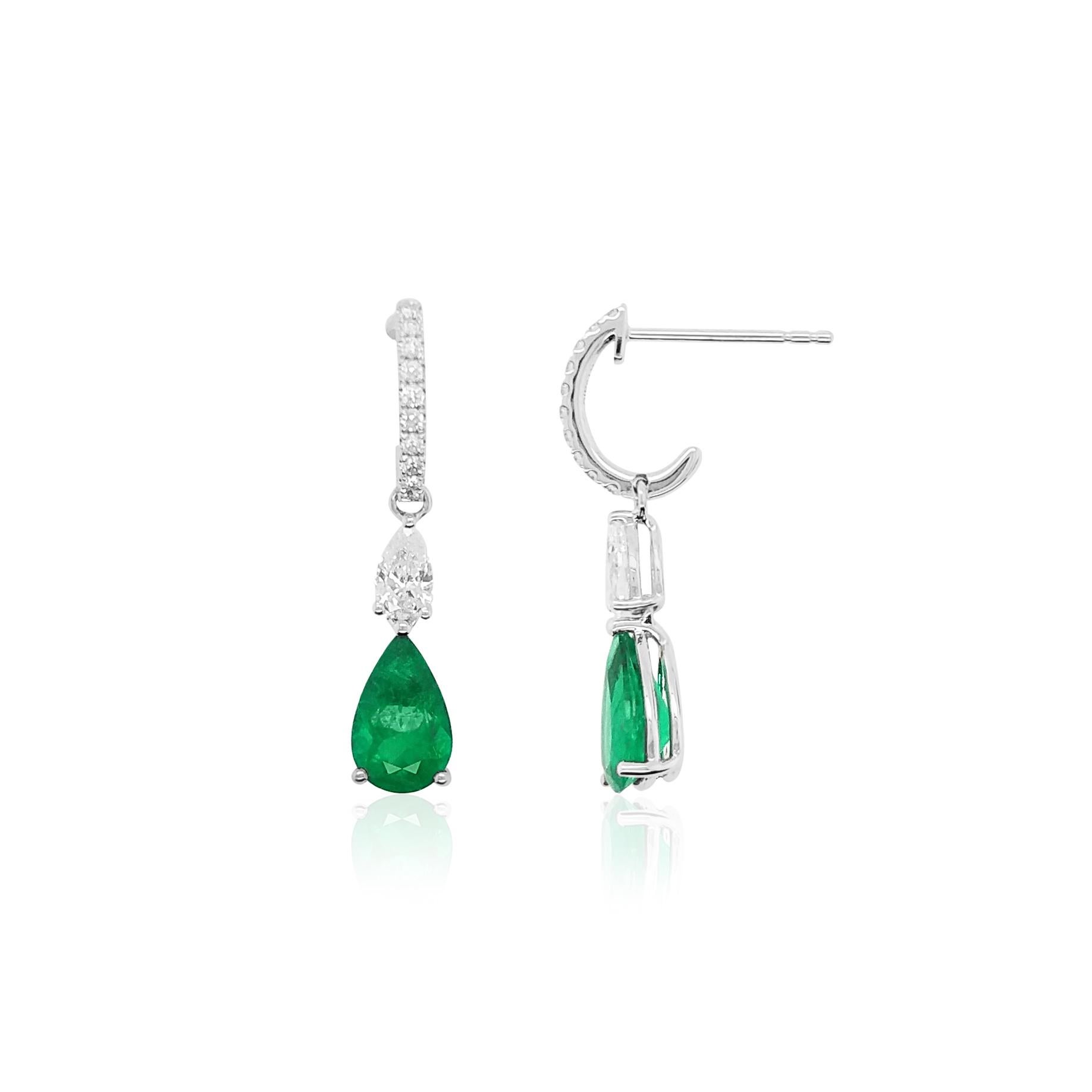 These elegant 18K gold earrings feature vibrant, natural colour Pear-shape Colombian Emerald beneath delicate diamonds stream. Set in 18 Karat white gold to perfectly enrich the colour of the emeralds and the sparkle of the diamonds, these intricate