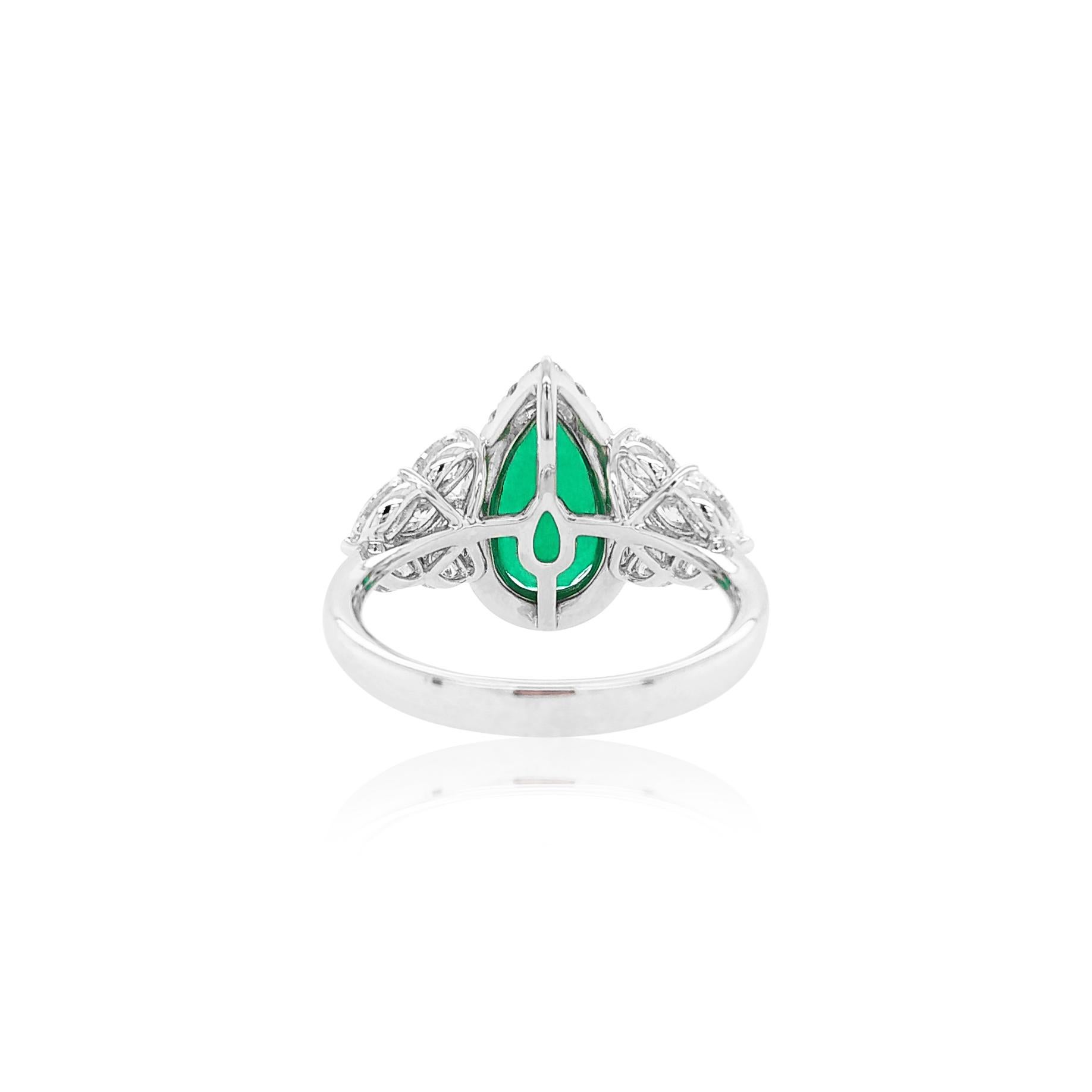 This mesmeric ring features one of their exceptional, a GRS certified Pear-shape natural Colombian Emerald at its centre. The incredibly rare emerald is perfectly accentuated by a halo of white diamonds surrounding it, and the sparkling