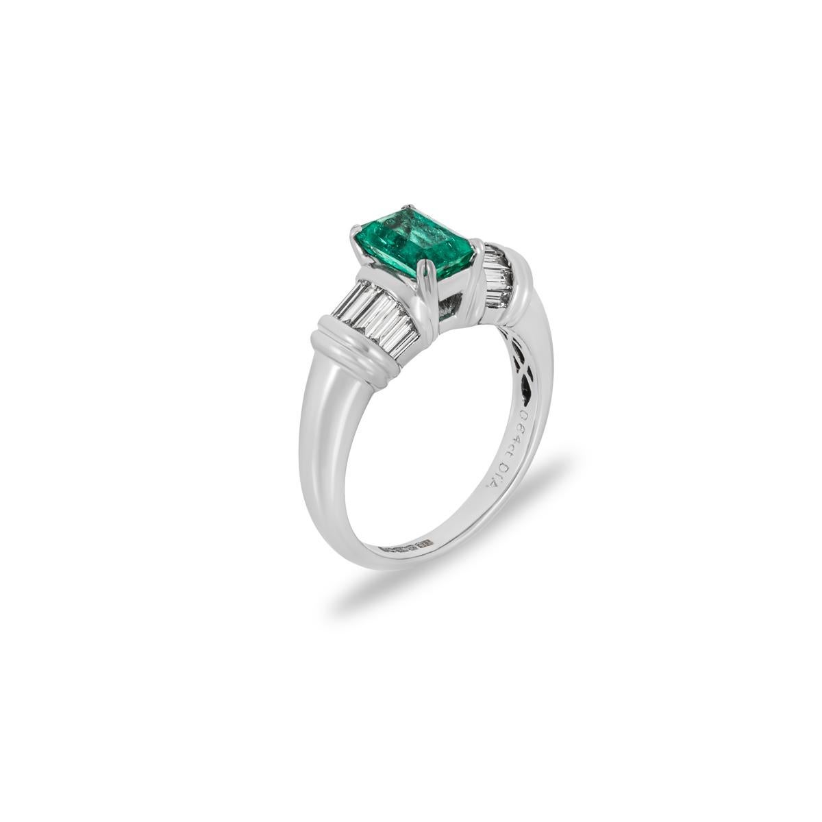 A gorgeous 18k white gold emerald and diamond ring. Set to the centre is an emerald cut Colombian emerald weighing 1.35ct and displaying a vibrant green hue. Accentuating the emerald are 12 tapered baguettes tension set to the shoulders with an