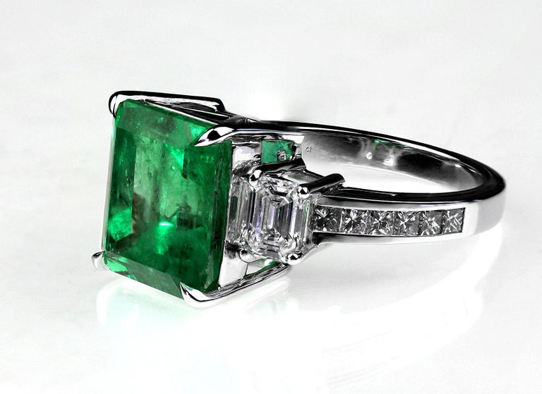 Certified Colombian emerald and diamond ring set in platinum.
The first thing that catches the eye with this ring is the stunning, vivid green colour and size of the emerald, enhanced by the sparkle of the bright white diamonds on either side.