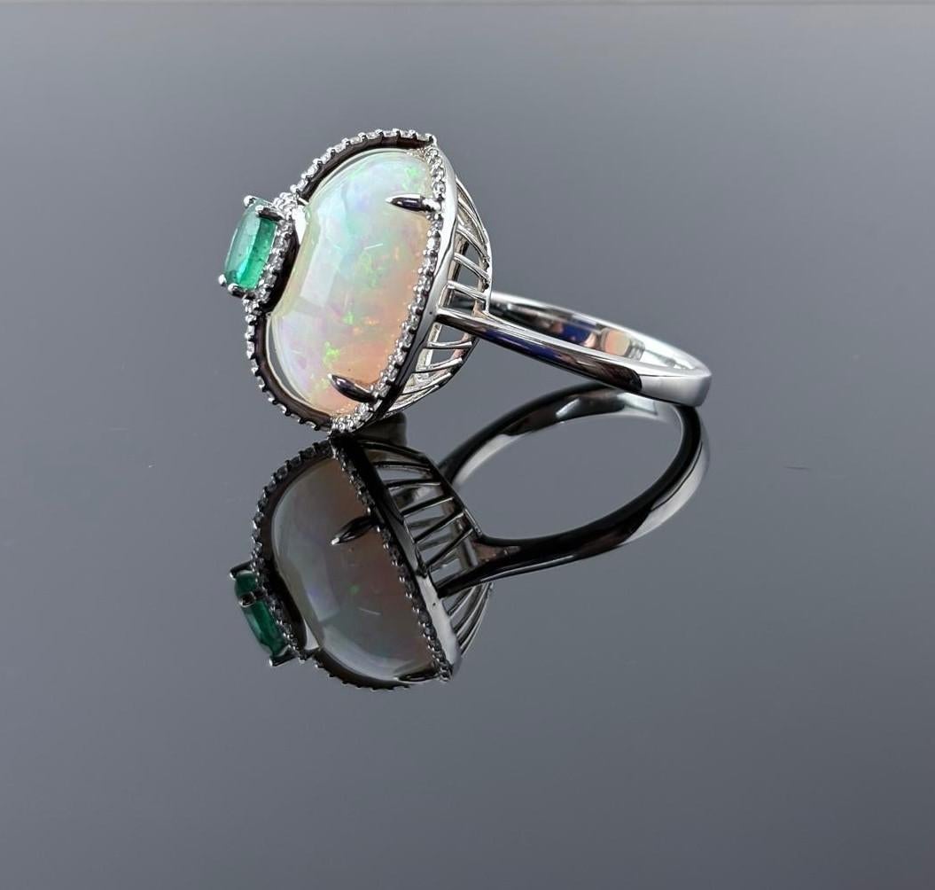Modern Certified Color Play Effect Oval Opal 18KT White Gold, Diamond And Emerald Ring For Sale