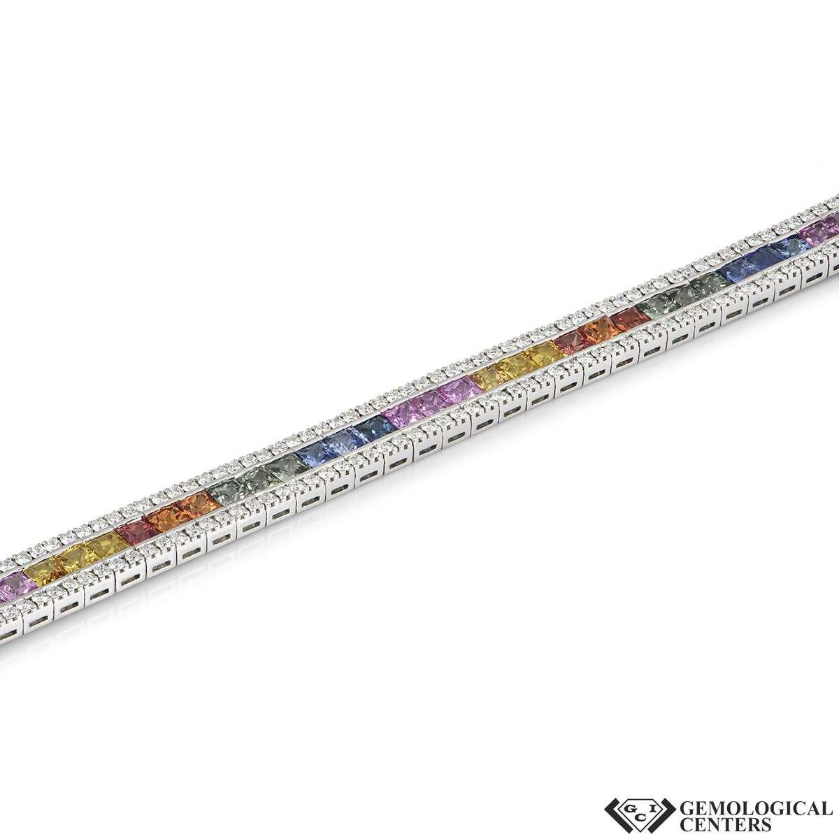 A striking 18k white gold diamond and sapphire bracelet. The bracelet consists of a boarder of round brilliant cut diamonds with square cut sapphires in an array of colours running through the centre. The diamonds have a total weight of 4.44ct are