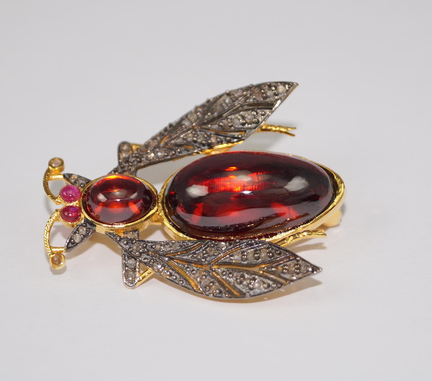 This Gorgeous Garnet Diamond brooch is a unique handcrafted art. It brings back the memory of the Victorian era. It has been crafted in 925 sterling silver with 18K Gold Plating over silver. Real Natural diamonds are studded in prong setting. Red