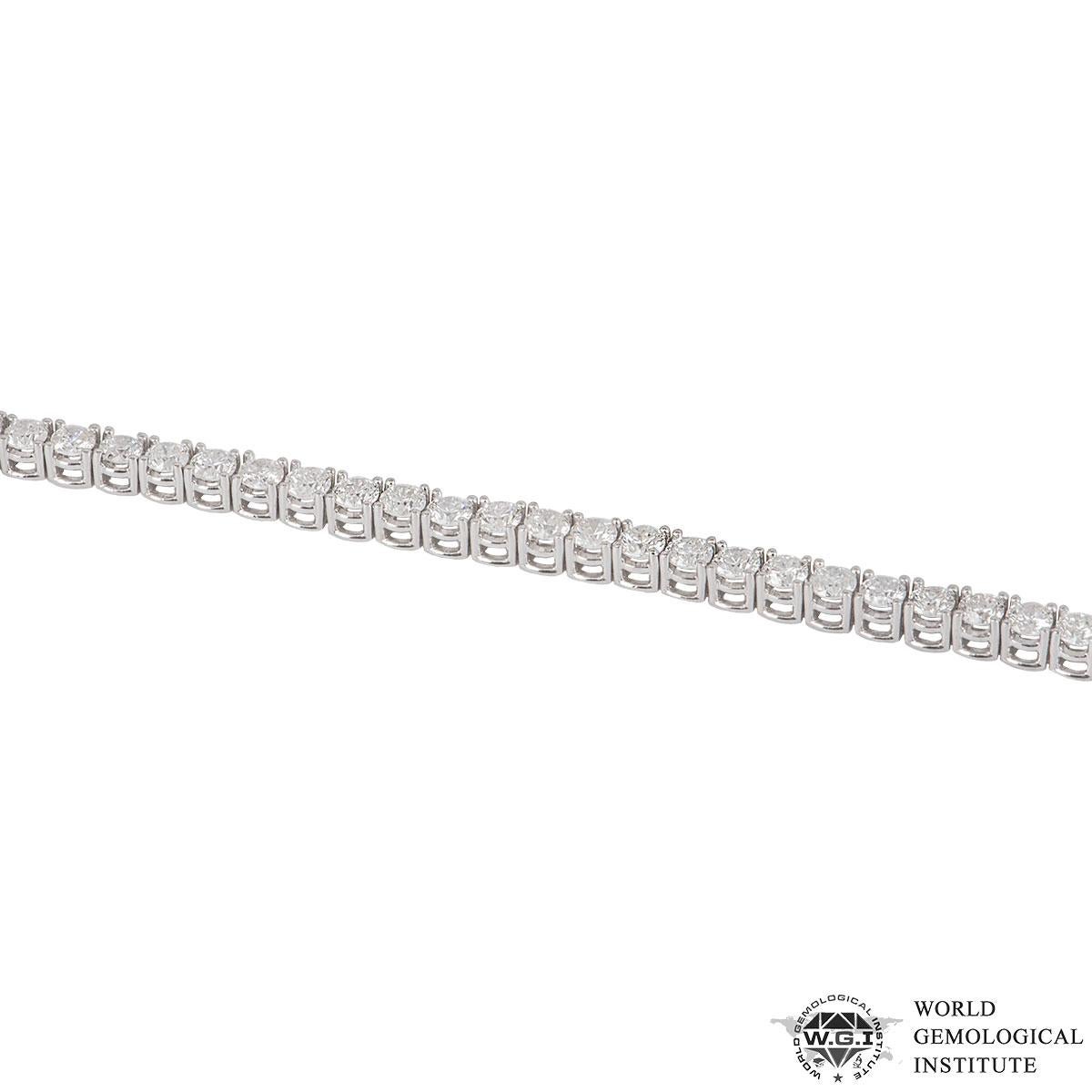 An 18k white gold diamond line bracelet. The bracelet is made up of 57 round brilliant cut diamonds in a four claw setting with a weight of 5.62ct, G-H colour and SI clarity. The bracelet measures 7.00 inches in length, complete with a box tongue