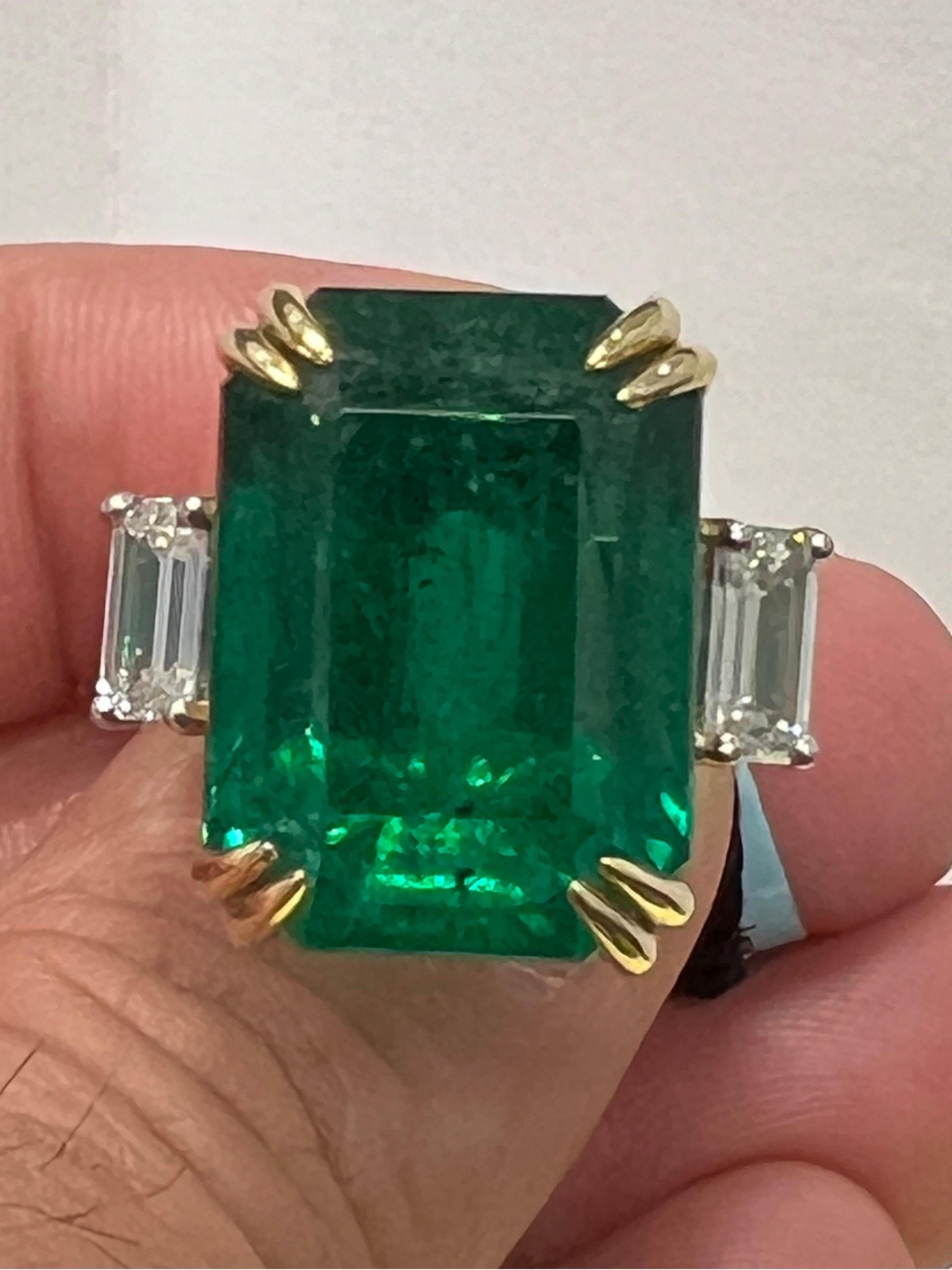 Extremely beautiful 30.27 carat emerald Octagon and two diamonds 0.70 and 0.71 carat emerald cut on either side is set in 18K two tone gold. You can easily resize the ring 2 size up and down if needed.  If you need more Picture and information,