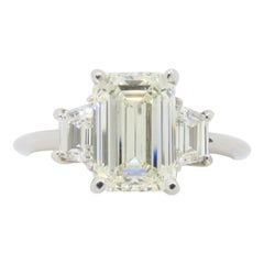 Anillo de compromiso de diamantes talla esmeralda certificados con diamantes laterales trapezoidales