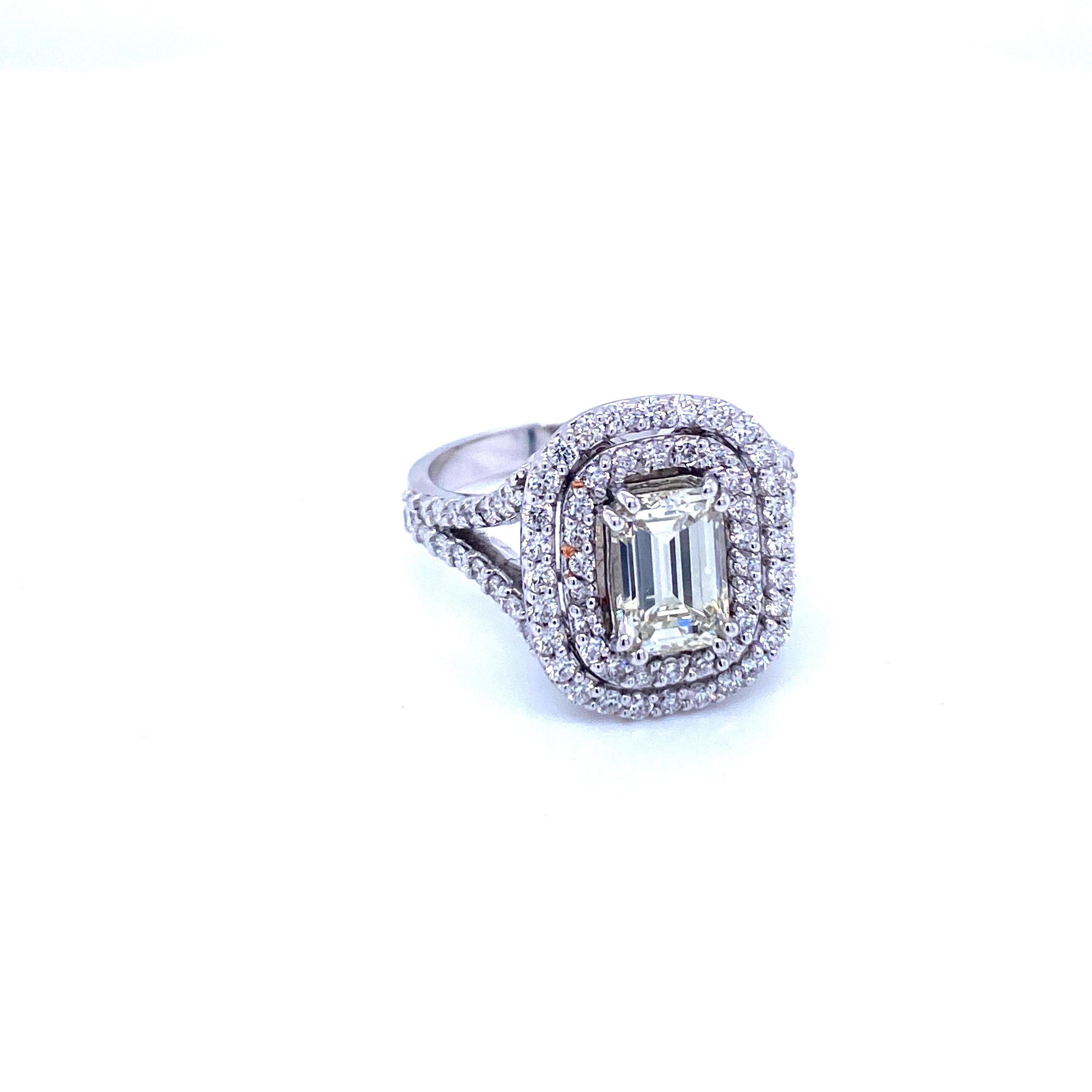 This beautiful handmade Diamond Ring is hand crafted in solid 18k white gold.
Made by master jewelers in Italy, the quality of the craftsmanship and setting is excellent.

The large center Diamond Emerald cut weight is 1.48 cts, graded K color vvs2