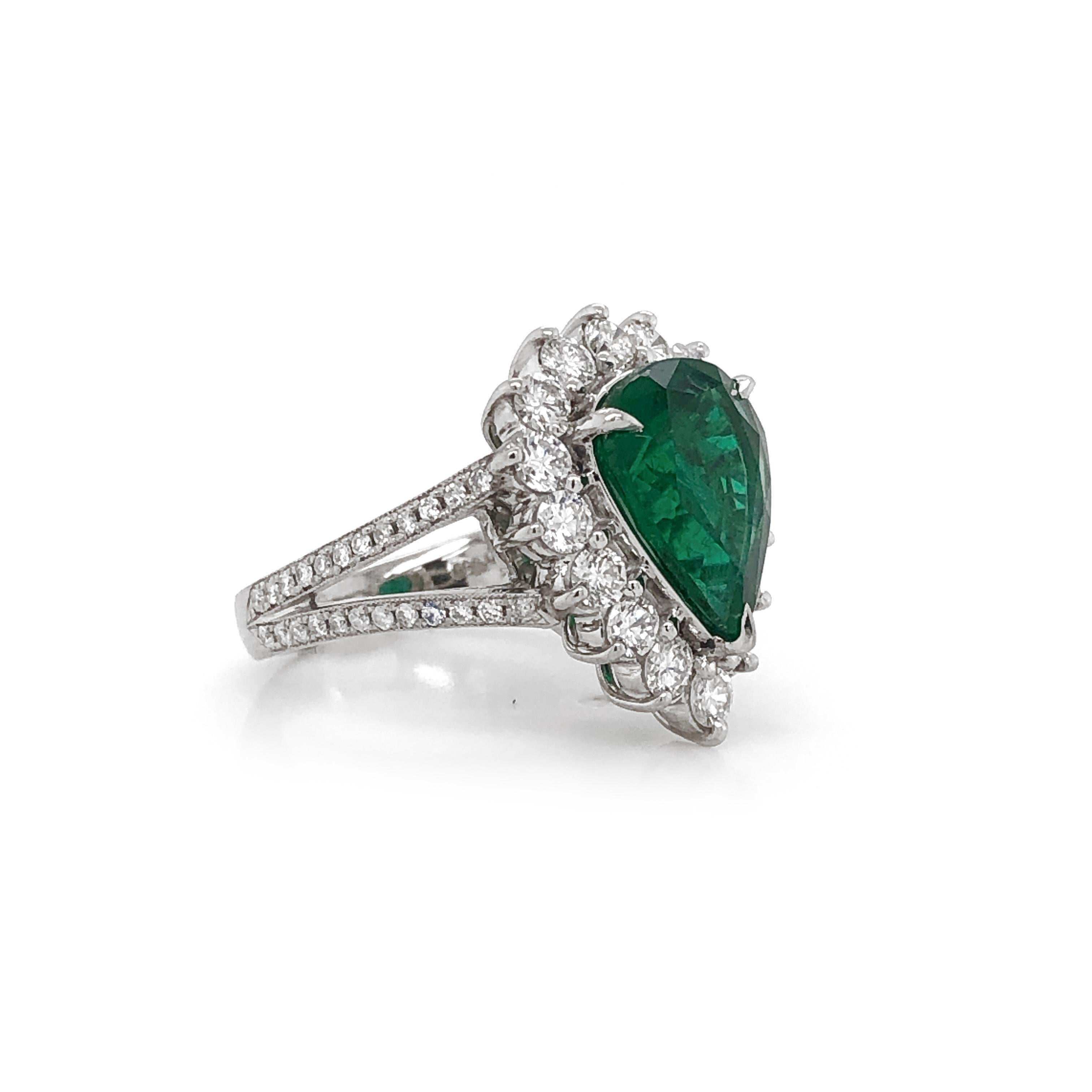 Elegantly styled pear cut green Zambian emerald 3.66 carat center stone - Certified.
Accented by round diamonds 1.36 in total. 
Diamonds are white and natural and in G-H Color Clarity VS.
Platinum 950 metal. 
Beautiful cocktail and engagement ring